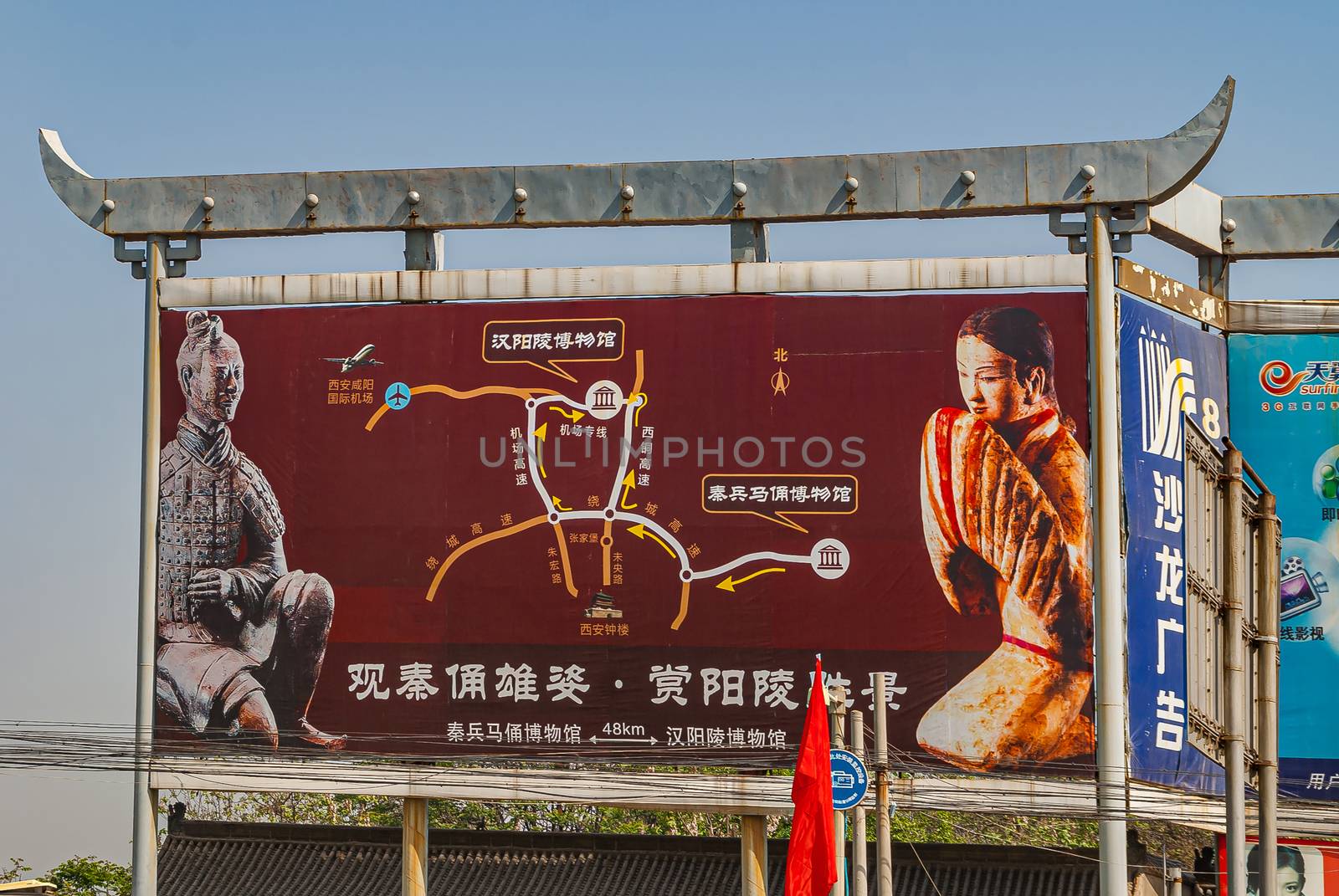 Xian, China - May 1, 2010: Terracotta Army museum. Colorful giant billboard along highway with directions to the museum and excavation site under ligh blue sky.