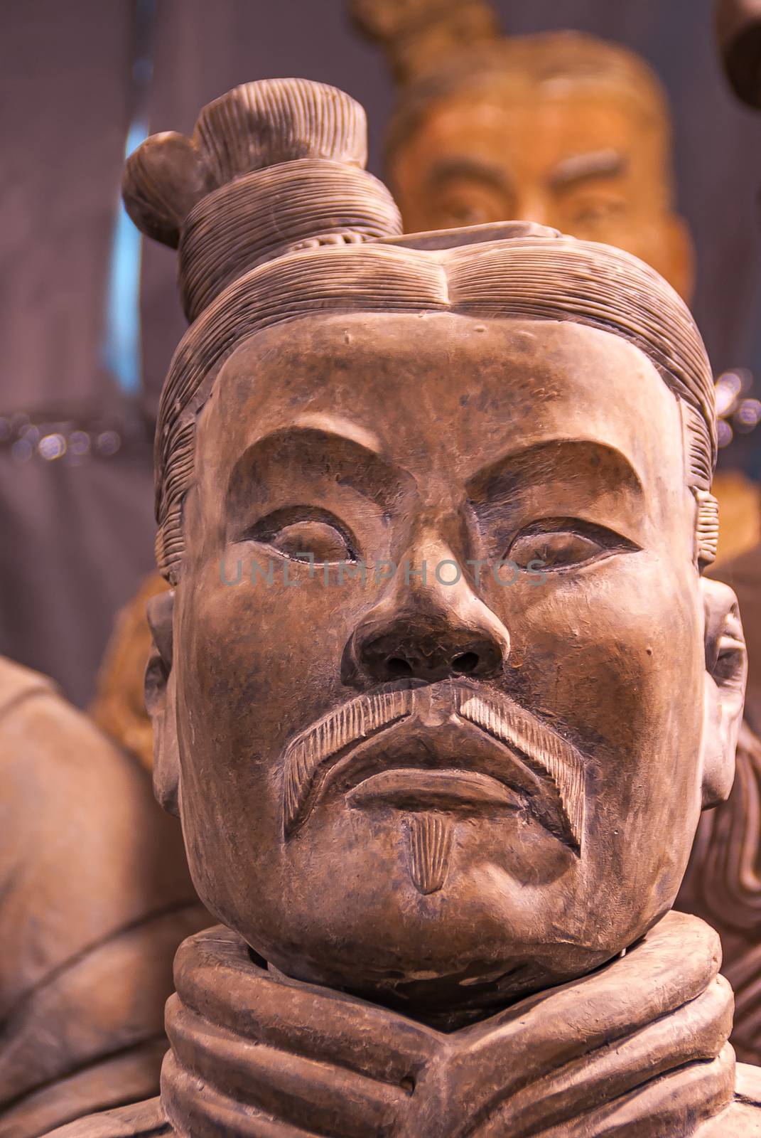 Closeup of stern officer face at Terracotta Army excavation hall by Claudine