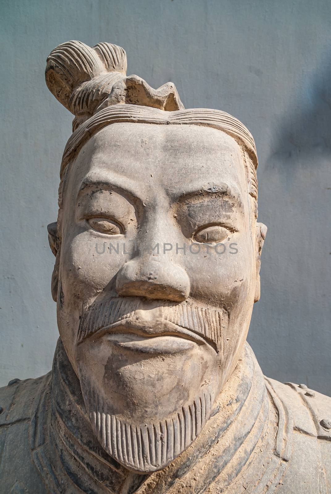 Face closeup of statue outside Terracotta Army museum, Xian, Chi by Claudine