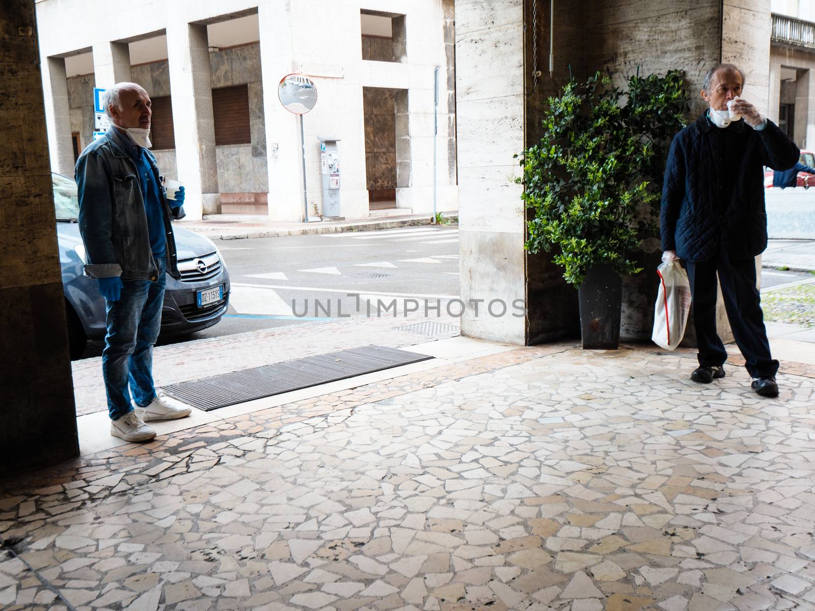 Cremona, Lombardy Italy,  may 2020 -  Bartender woman  at cafe bar in city center slowly open and make drinks only to go and some usual customers return  - new stage of coronavirus outbreak