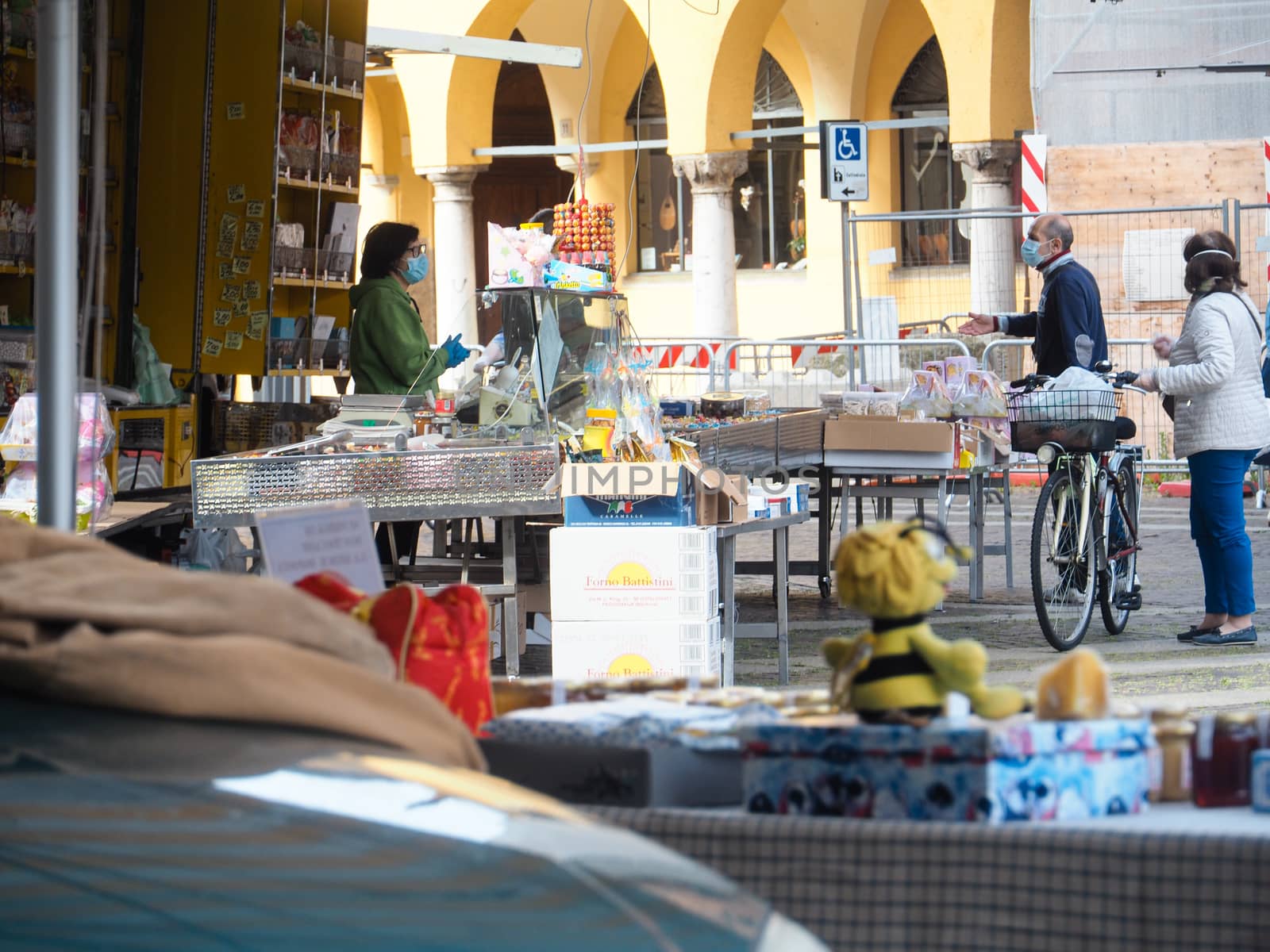 Cremona, Lombardy, Italy - 16 th may 2020 - People grocery shopping socially distance d in local biologic open air  food market wearing protection facial mask to prevent against contagion of coronavirus infection disease