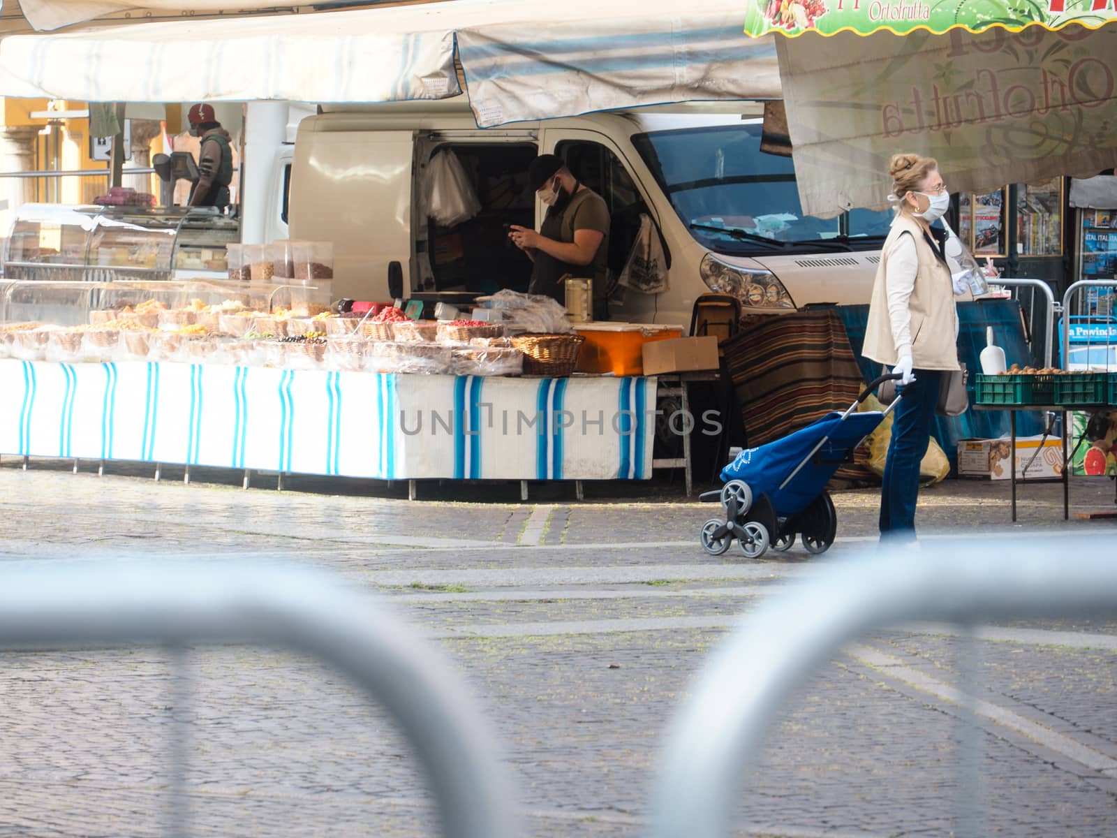 Cremona, Lombardy, Italy - 16 th may 2020 - People grocery shopping socially distance d in local biologic open air  food market wearing protection facial mask to prevent against contagion of coronavirus infection disease