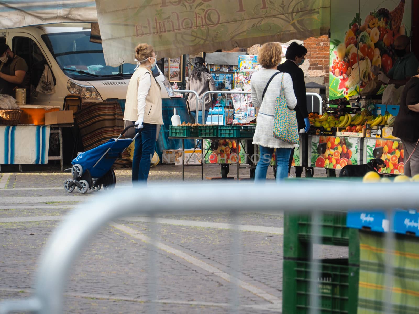 Cremona, Lombardy, Italy - 16 th may 2020 - People grocery shopping socially distance d in local biologic open air  food market wearing protection facial mask to prevent against contagion of coronavirus infection disease