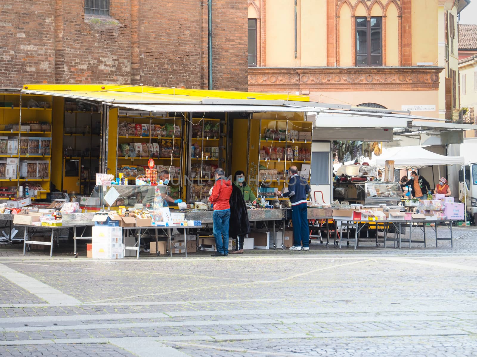 Cremona, Lombardy, Italy - 16 th may 2020 - People grocery shopping socially distance d in local biologic open air  food market wearing protection facial mask to prevent against contagion of coronavirus infection disease