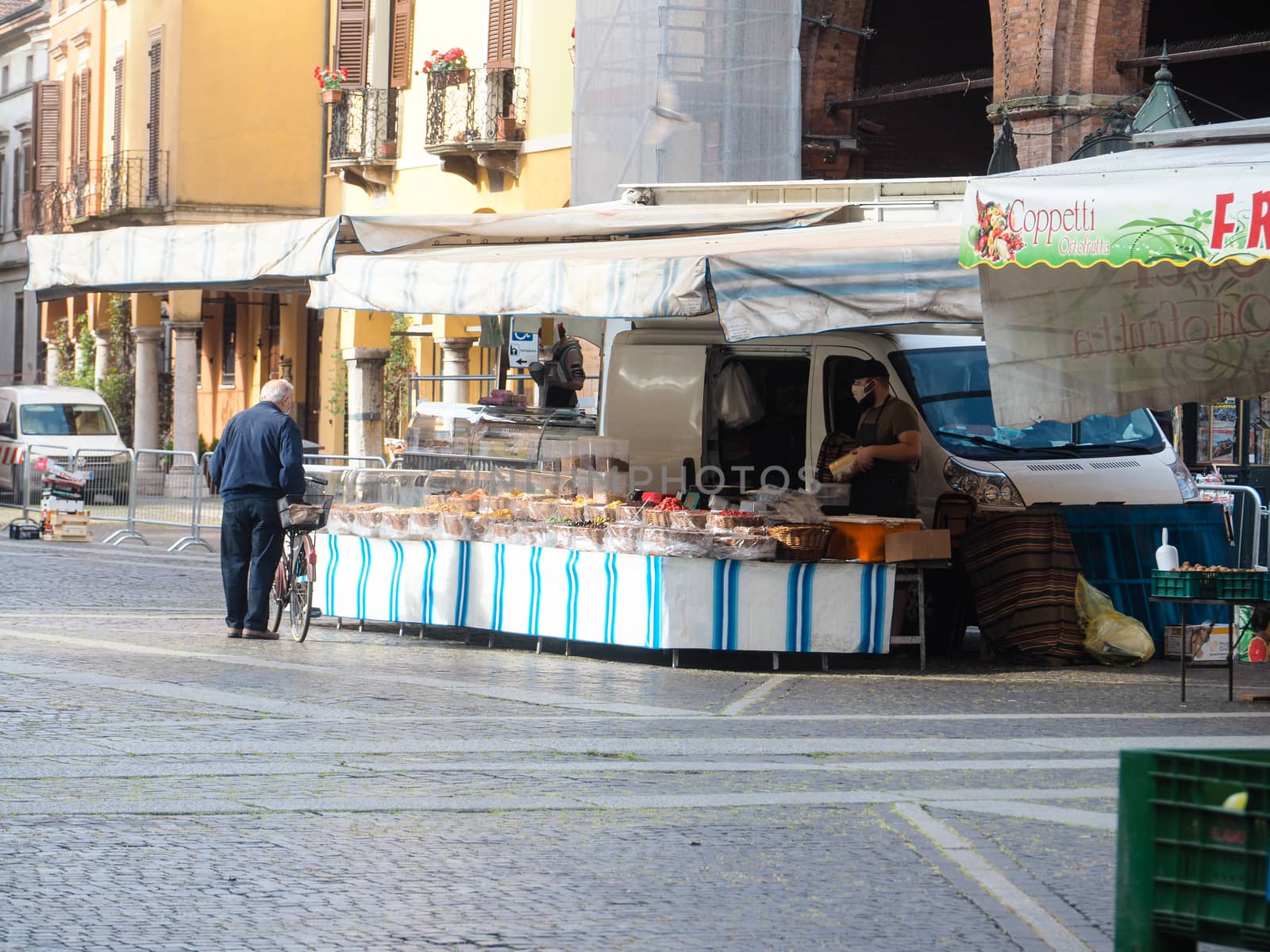 Cremona, Lombardy, Italy - 16 th may 2020 - People grocery shopping socially distance d in local biologic open air  food market wearing protection facial mask to prevent against contagion of coronavirus infection disease