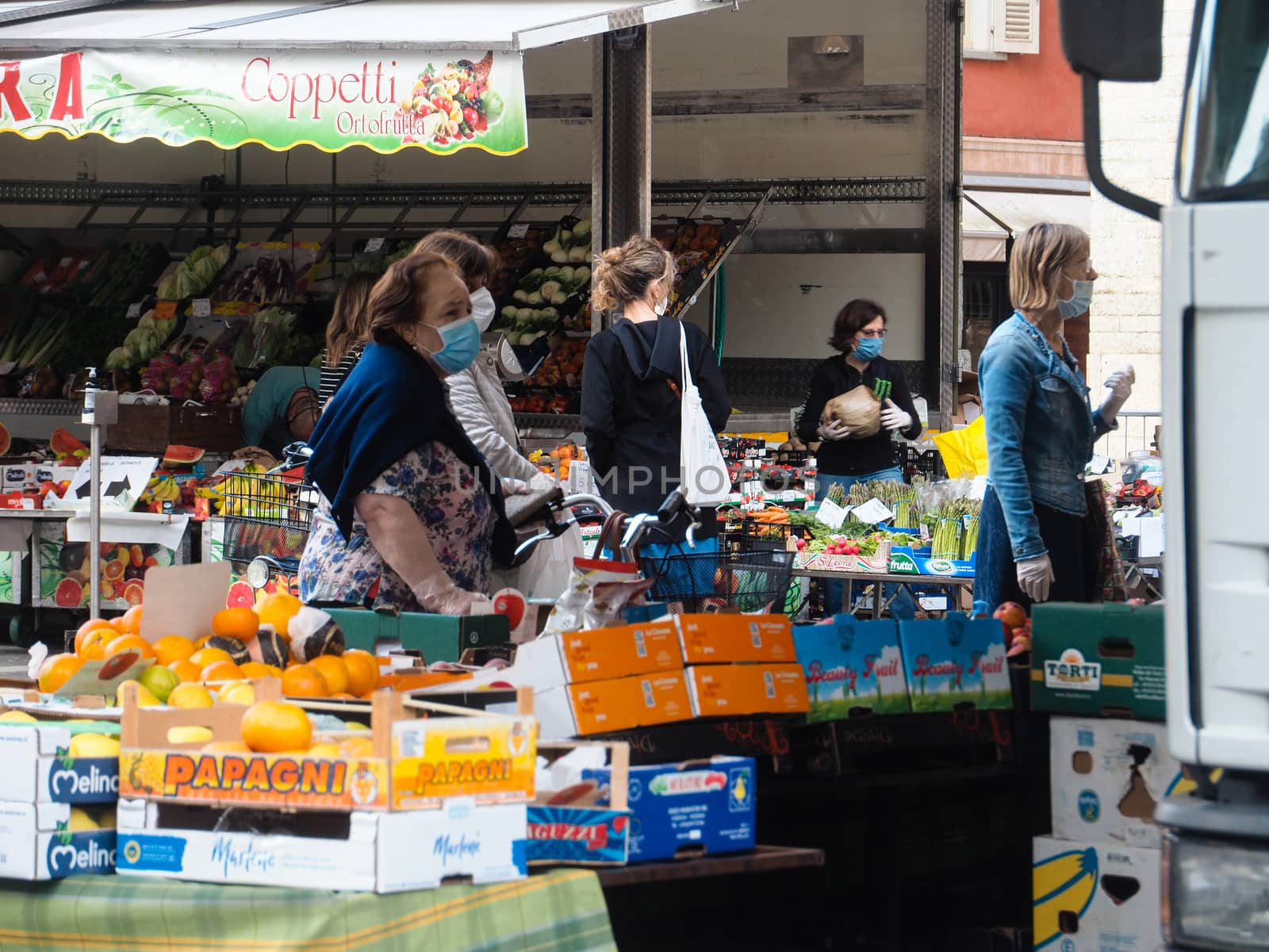 Cremona, Lombardy, Italy - 16 th may 2020 - People grocery shopping socially distance d in local biologic open air  food market wearing protection facial mask to prevent against contagion of coronavirus infection disease