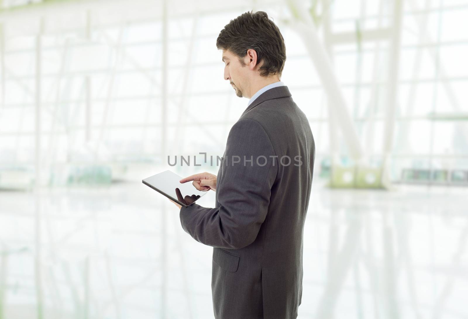 young businessman working with a tablet pc, at the office