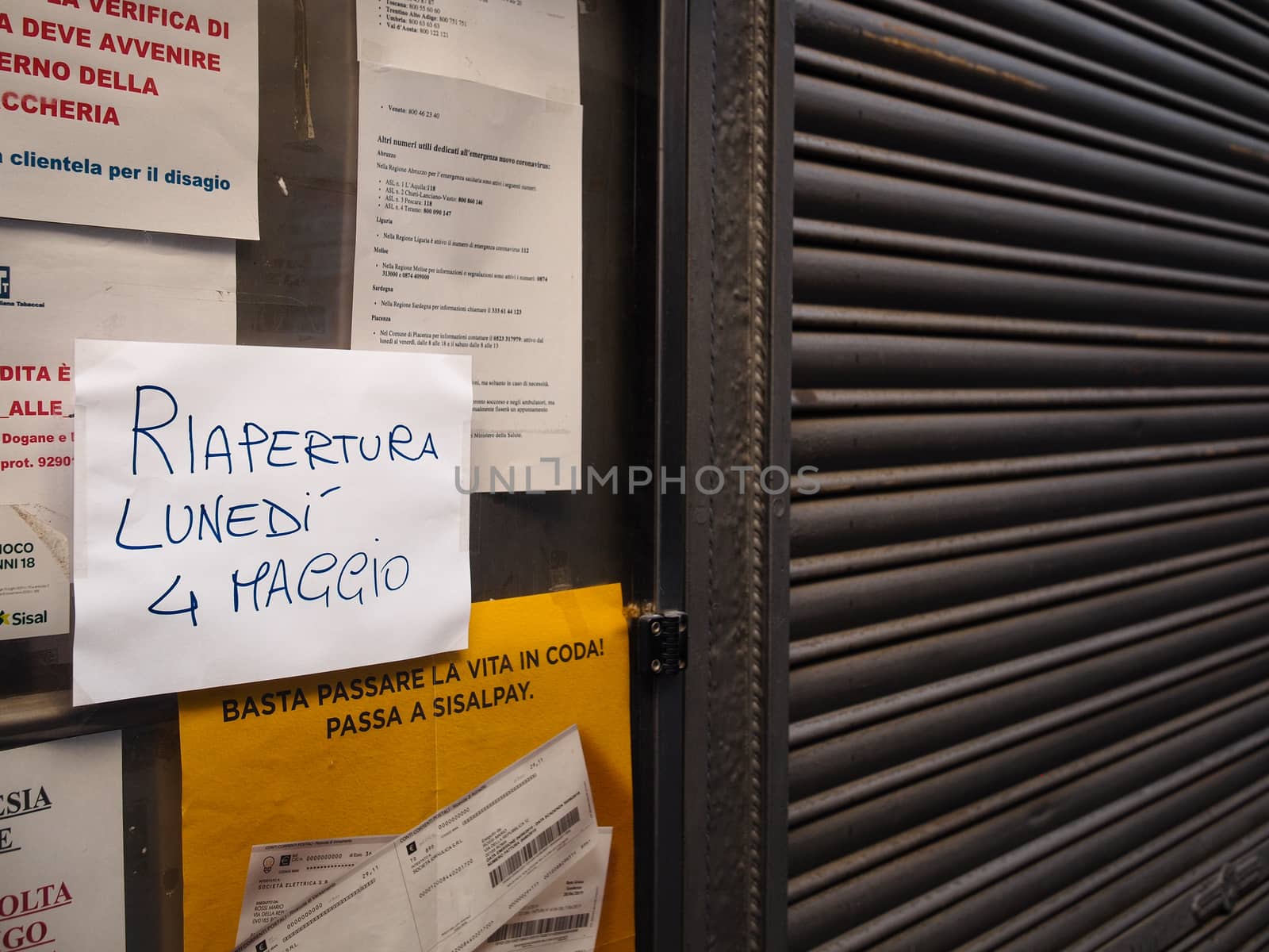 Cremona, Lombardy, Italy - April 30 th - May 1st 2020 - closed bars  and general commerce  during coronavirus lockdown and economic crisis. Italian signs