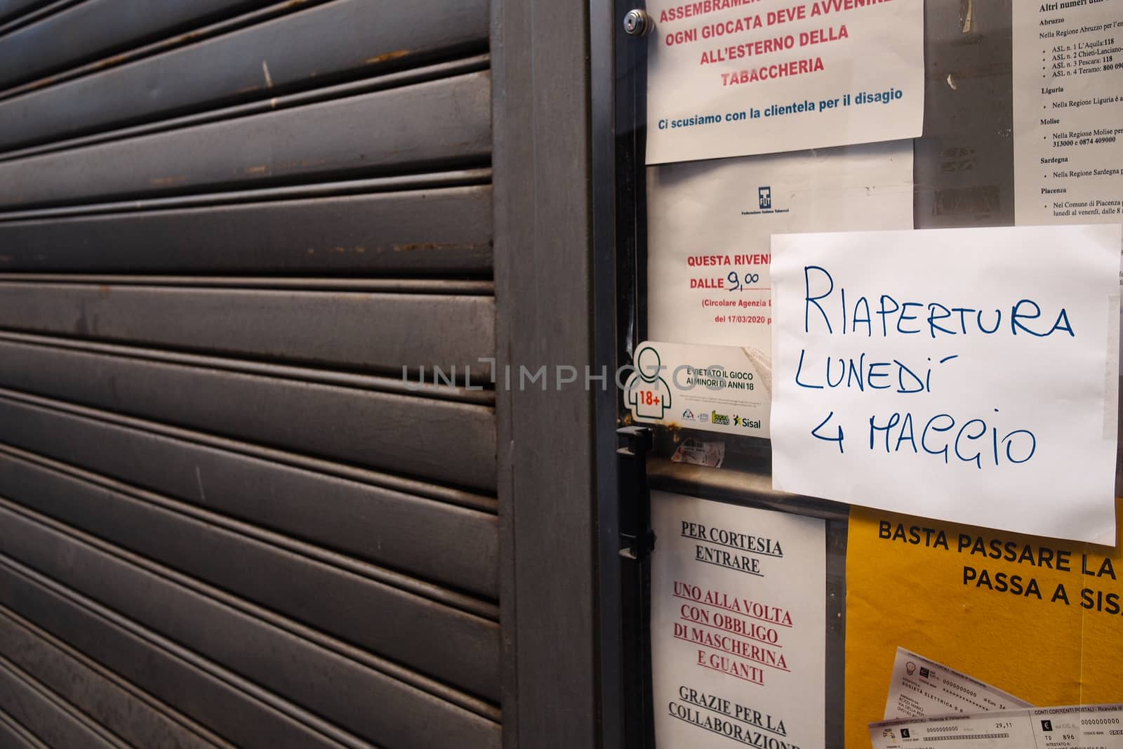 Cremona, Lombardy, Italy - April 30 th - May 1st 2020 - closed bars  and general commerce  during coronavirus lockdown and economic crisis. Italian signs