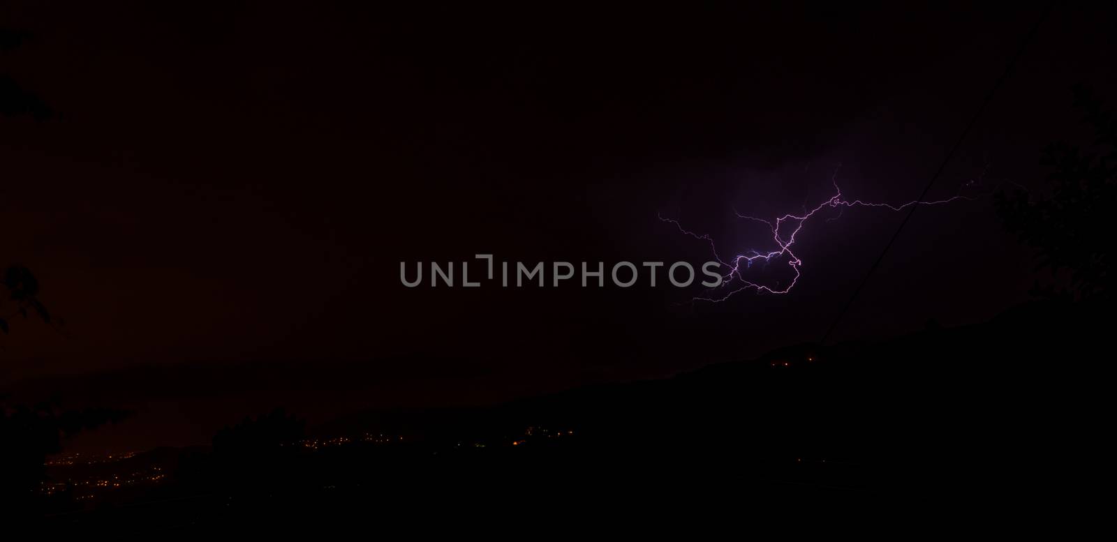Lightning bolts during an evening thunderstorm over Geres National Park, Amares, Portugal