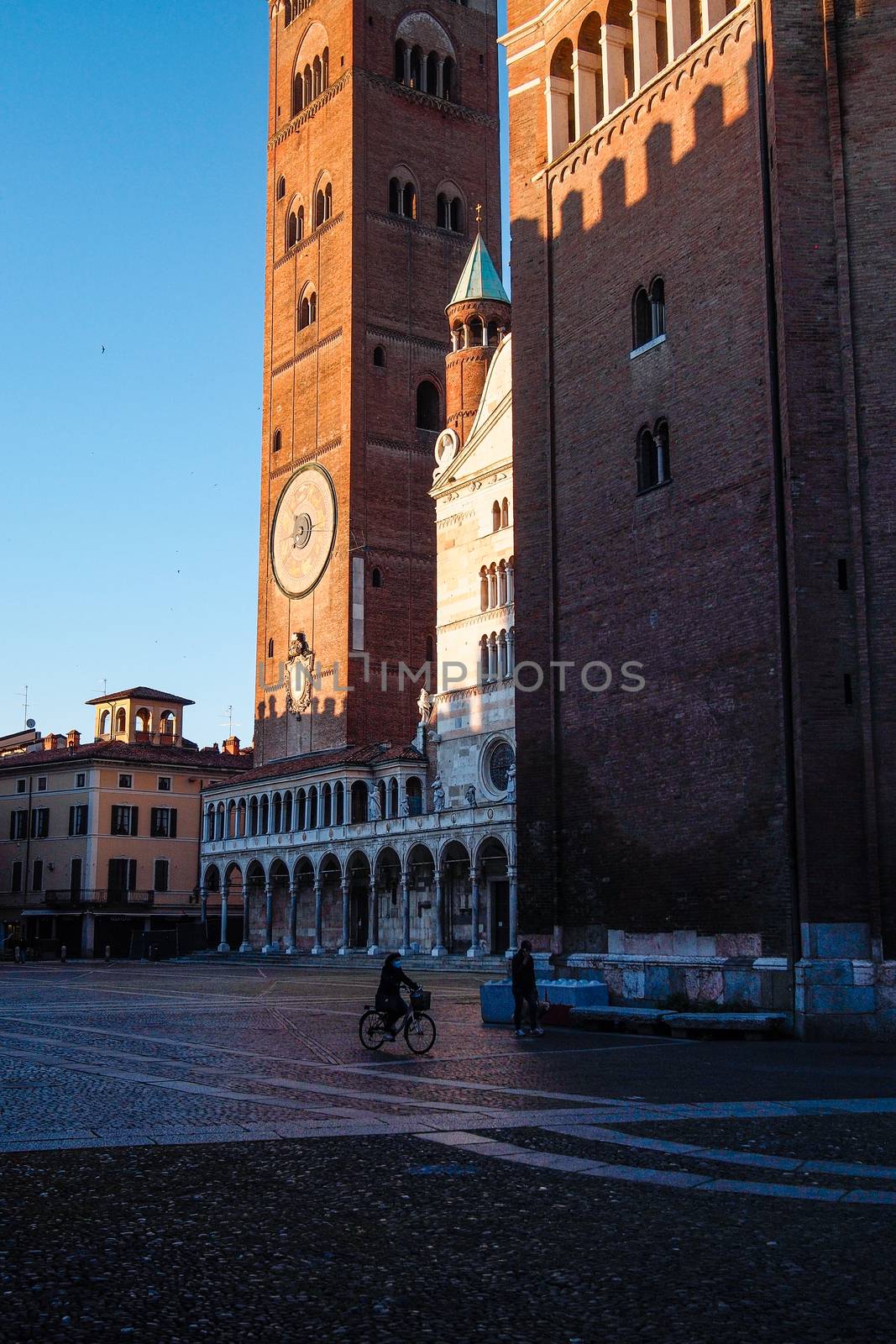 Cremona, Lombardy, Italy - April 30 th - May 1st 2020 - people biking walking dog walking in the center during covid 19  lockdown and economic crisis in Lombardy affected region.