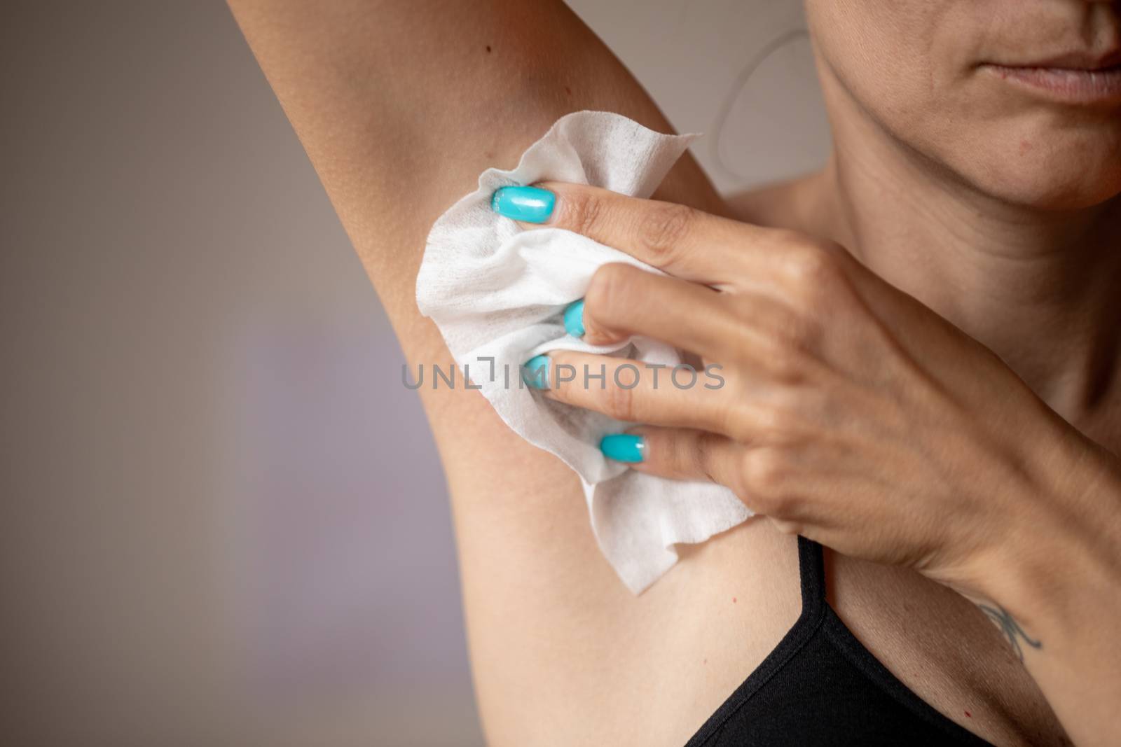 Old woman wiping the armpit with wet wipes, perspiration, sweat