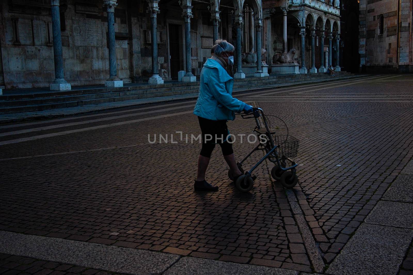 Cremona, Lombardy, Italy - April 30 th - May 1st 2020 - people biking walking dog walking in the center during covid 19  lockdown and economic crisis in Lombardy affected region.