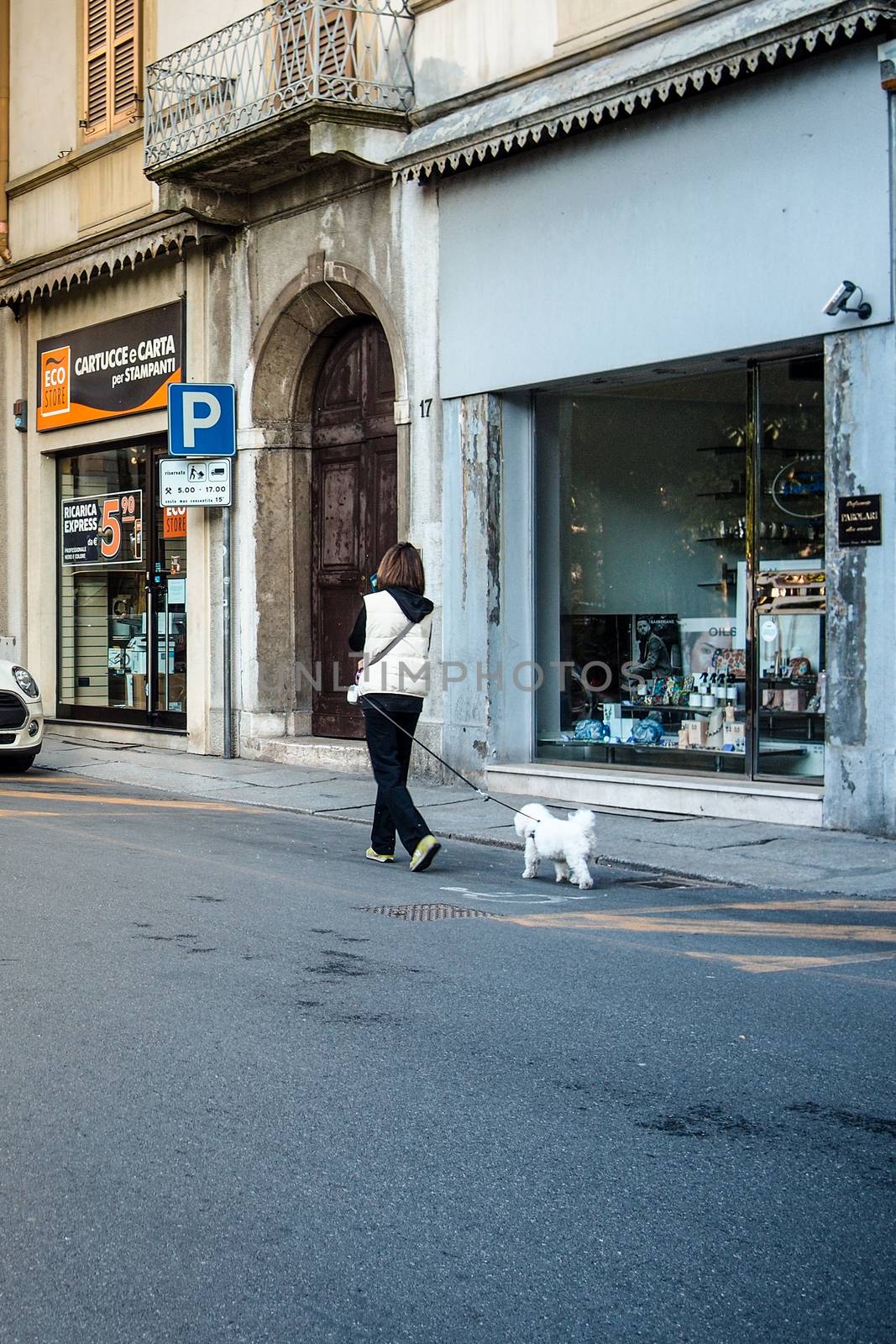 Cremona, Lombardy, Italy - April 30 th - May 1st 2020 - people biking walking dog walking in the center during covid 19  lockdown and economic crisis in Lombardy affected region.