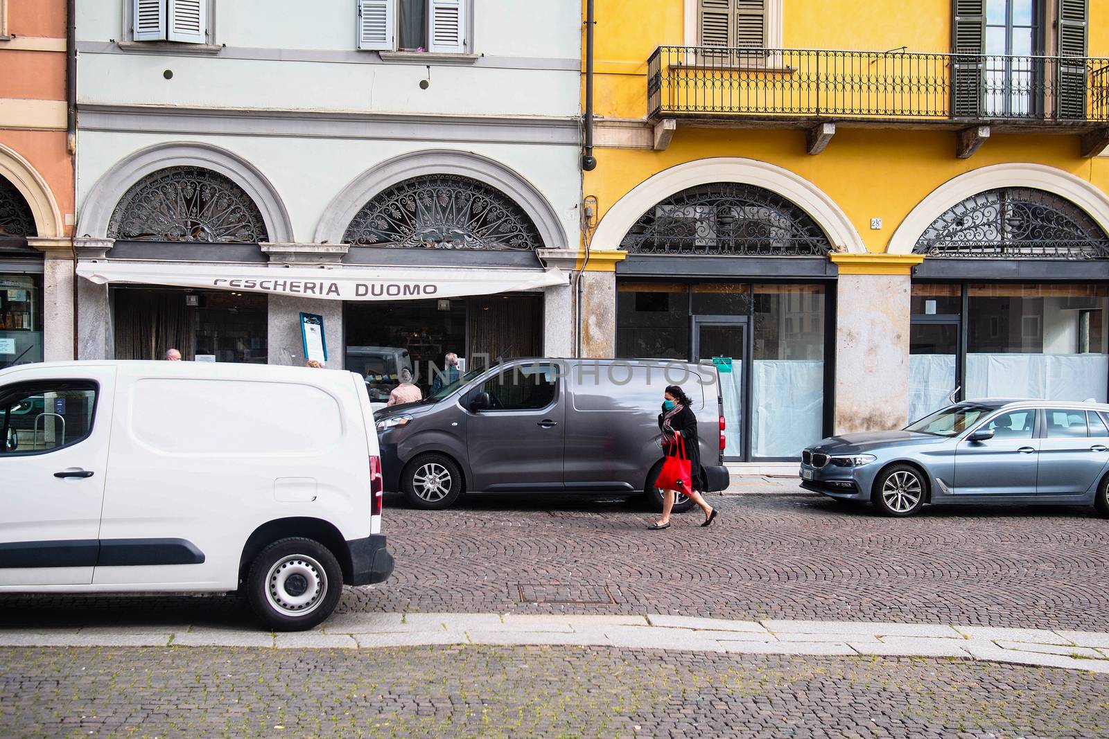 Cremona, Lombardy, Italy - April 30 th - May 1st 2020 - people biking walking dog walking in the center during covid 19  lockdown and economic crisis in Lombardy affected region.