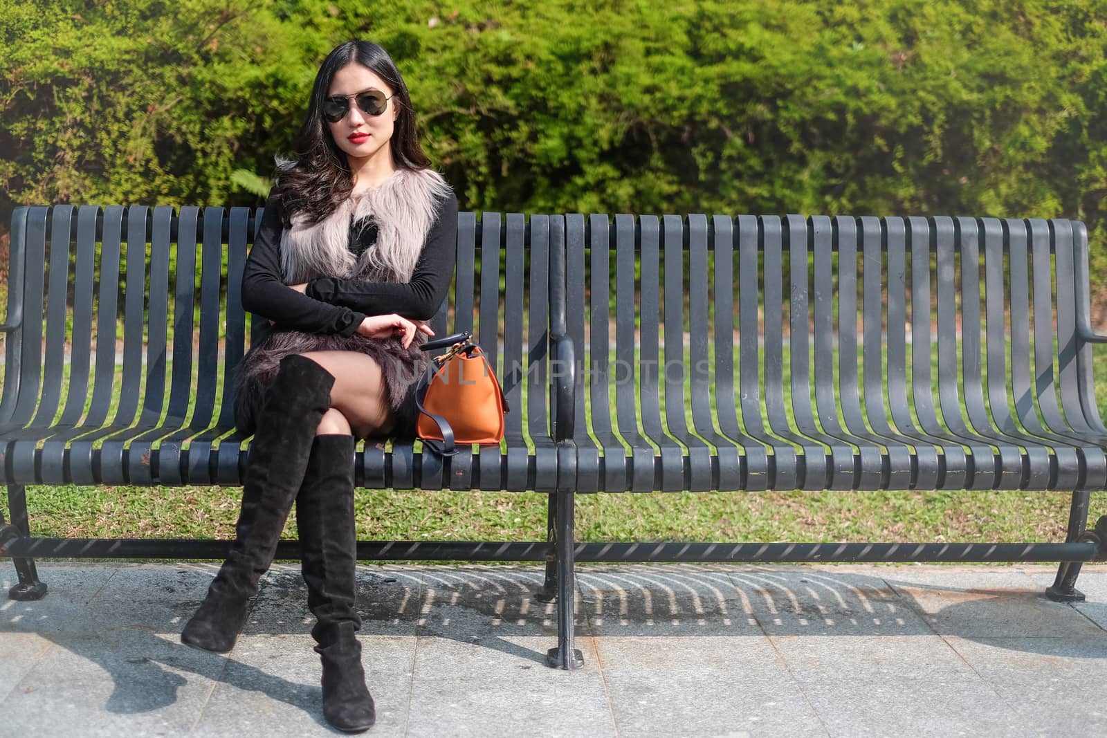 Beautiful young woman sunglass resting in park