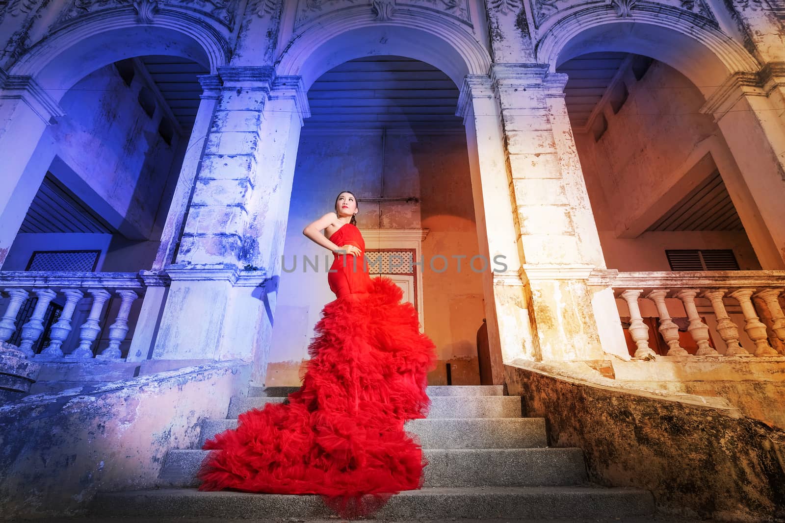 Beautiful woman wearing fashionable red dress by Surasak