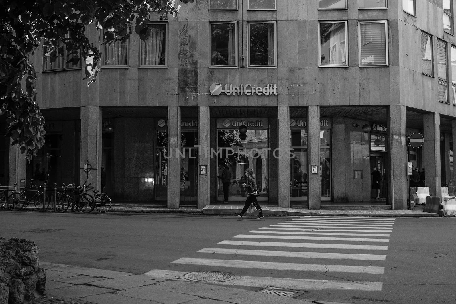 Cremona, Lombardy, Italy - April 30 th - May 1st 2020 - people biking walking dog walking in the center during covid 19  lockdown and economic crisis in Lombardy affected region.