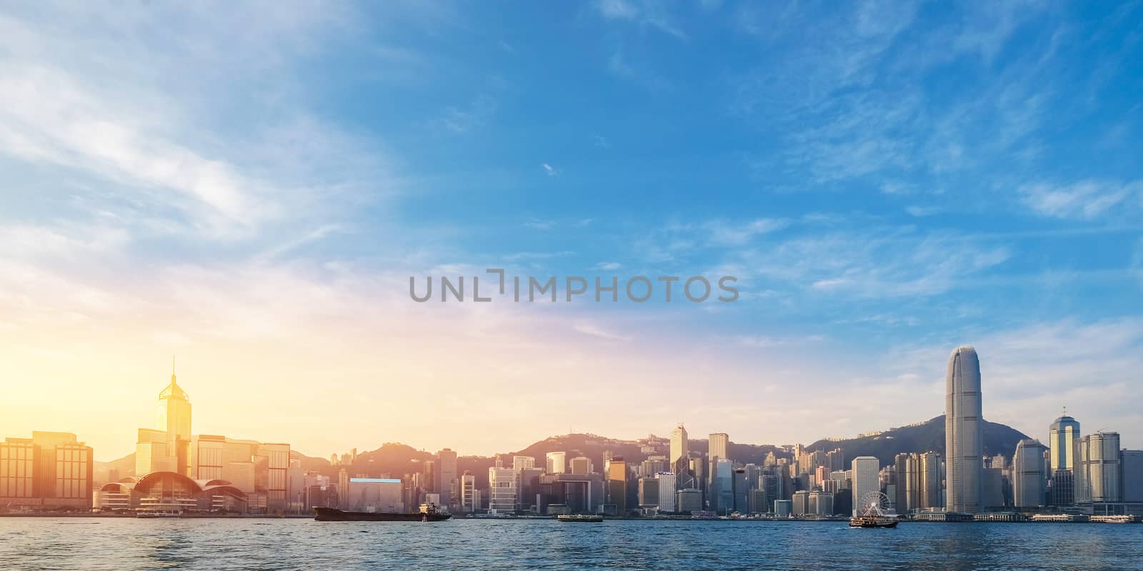 Hong Kong's Victoria Harbour in sunrise with text welcome to Hon by Surasak