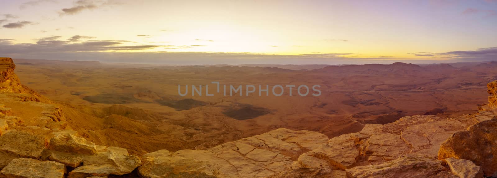 Panoramic sunrise view of Makhtesh (crater) Ramon, in the Negev Desert, Southern Israel. It is a geological landform of a large erosion cirque