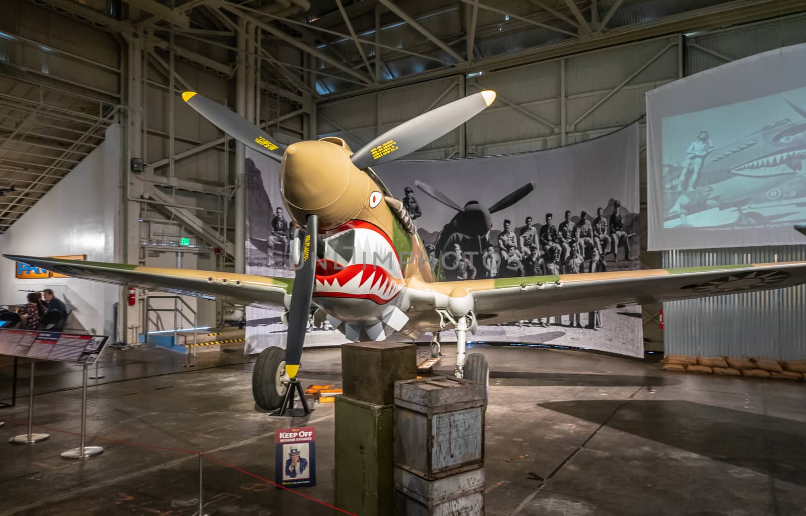 Oahu, Hawaii, USA. - January 10, 2020: Pearl Harbor Aviation Museum. Curtiss P-40E Warhawk stands in hangar. Operated by Canadian Flying Tigers during war.