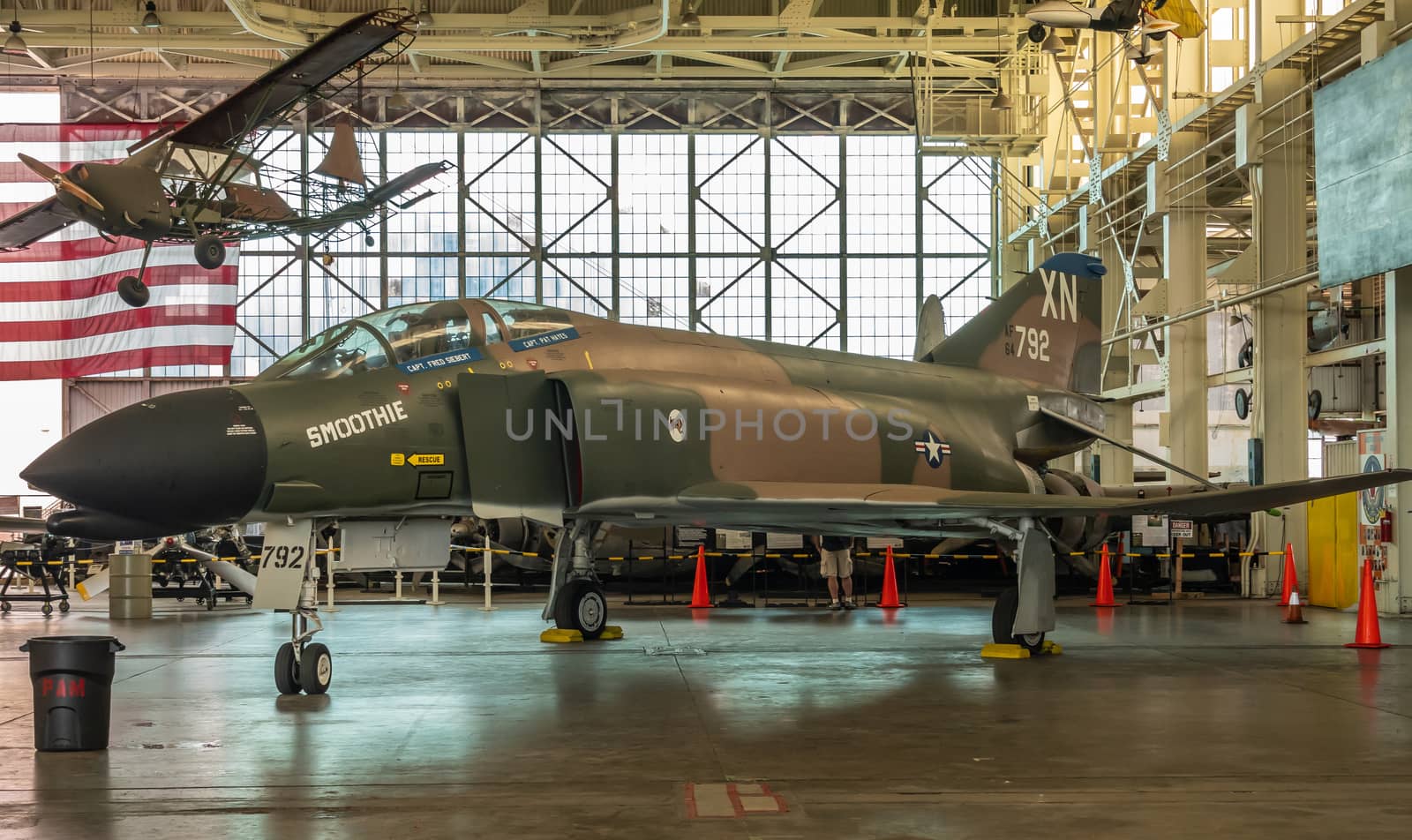 Oahu, Hawaii, USA. - January 10, 2020: Pearl Harbor Aviation Museum. Green XN 792 fighter jet Smoothie. Beige roof. Natural light through windows.