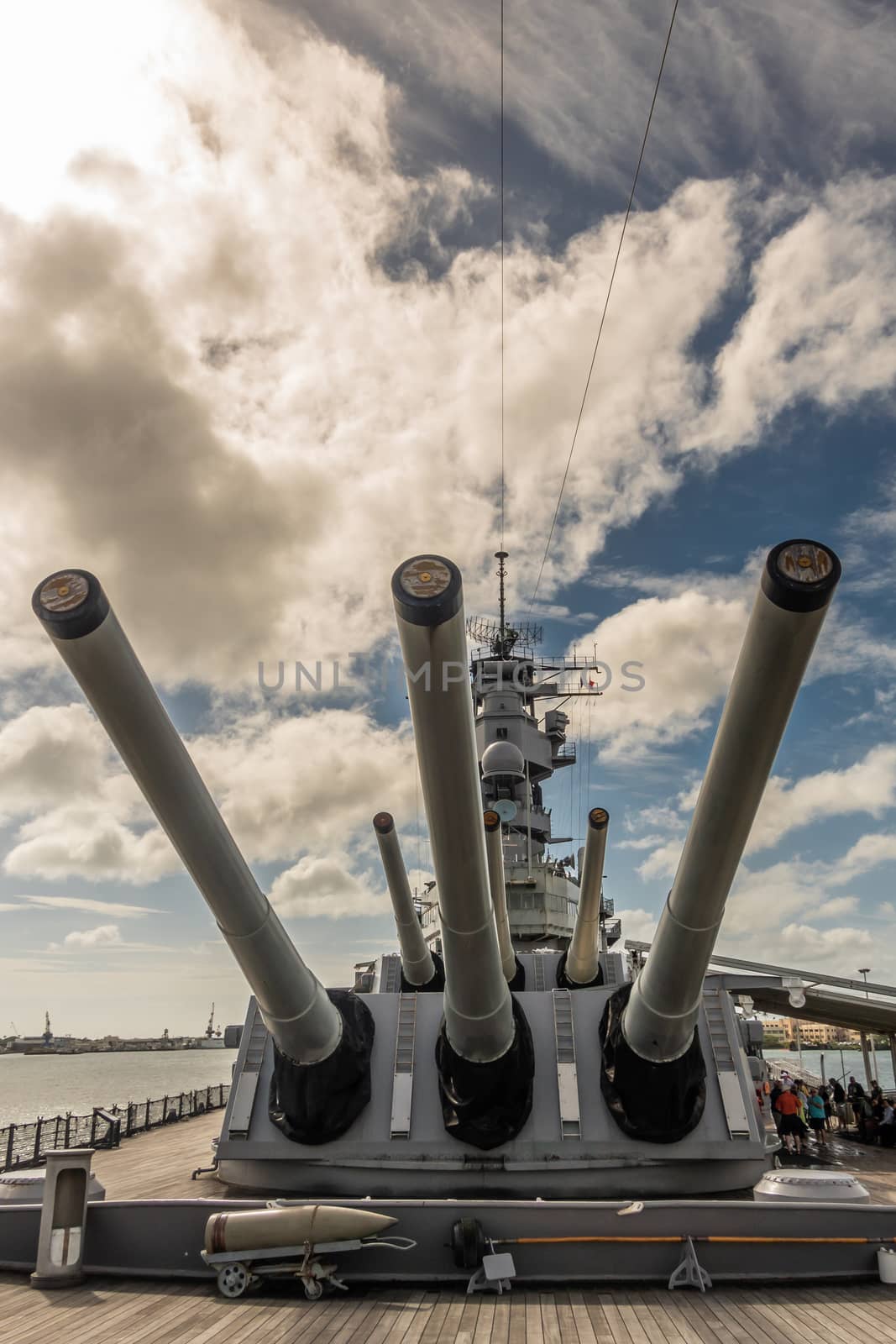 Oahu, Hawaii, USA. - January 10, 2020: Pearl Harbor. Closeup of Big guns on bow of USS Missouri Battle Ship under blue cloudscape. People on deck.