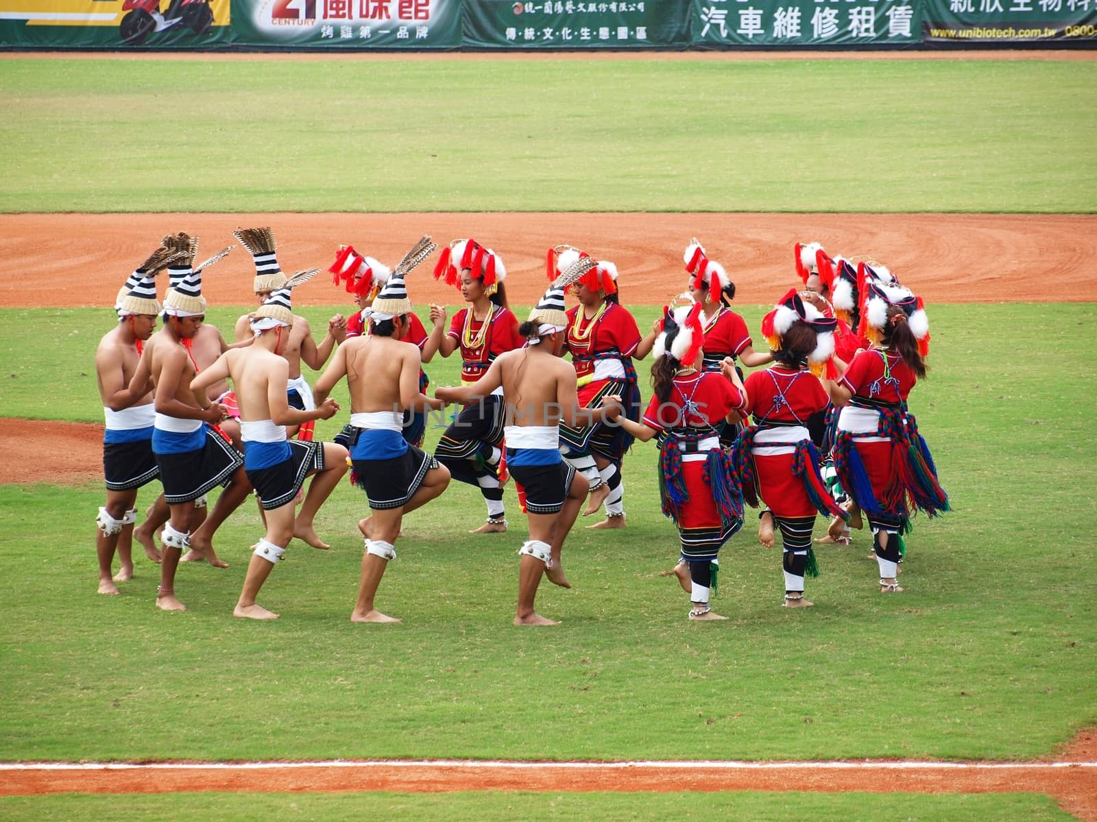 PINGTUNG, TAIWAN, APRIL 8: Aboriginal dancers perform before a Pro Baseball League game between the President Lions and the Lamigo Monkeys. The Lions won 2:0 on April 8, 2012 in Pingtung.