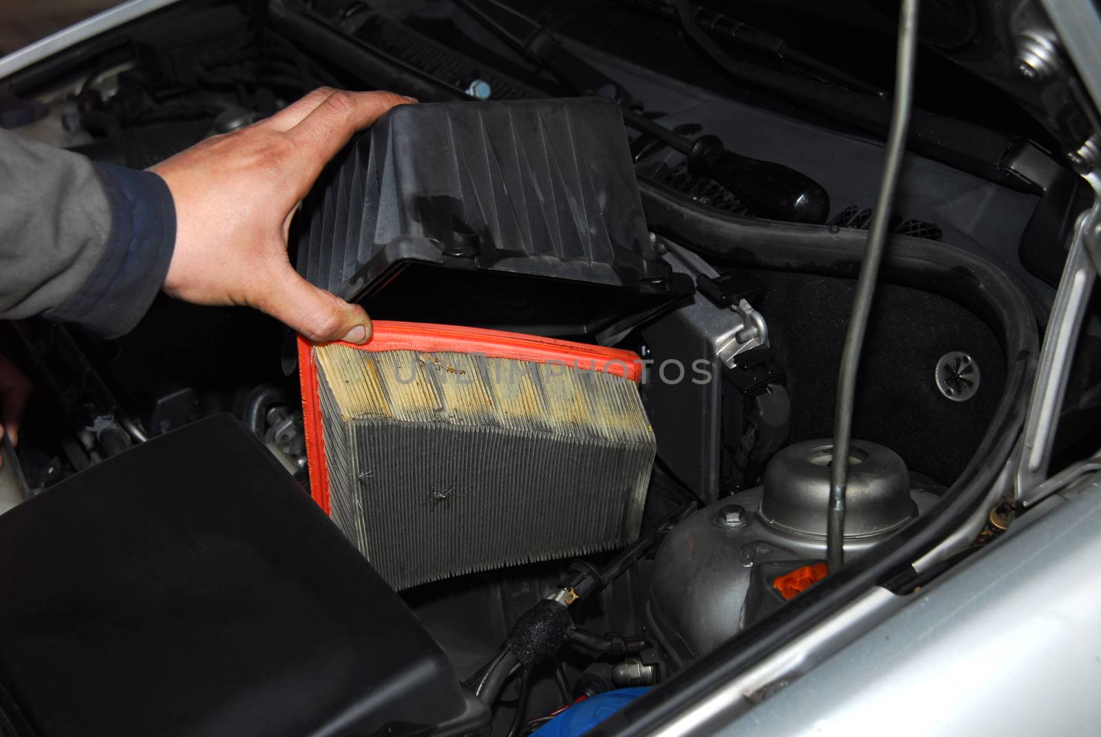 servicer is holding an old air filter