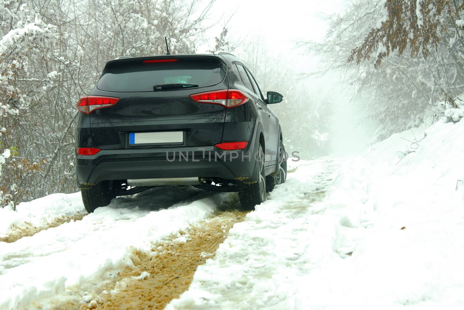 SUV stands on a mountain road in snow