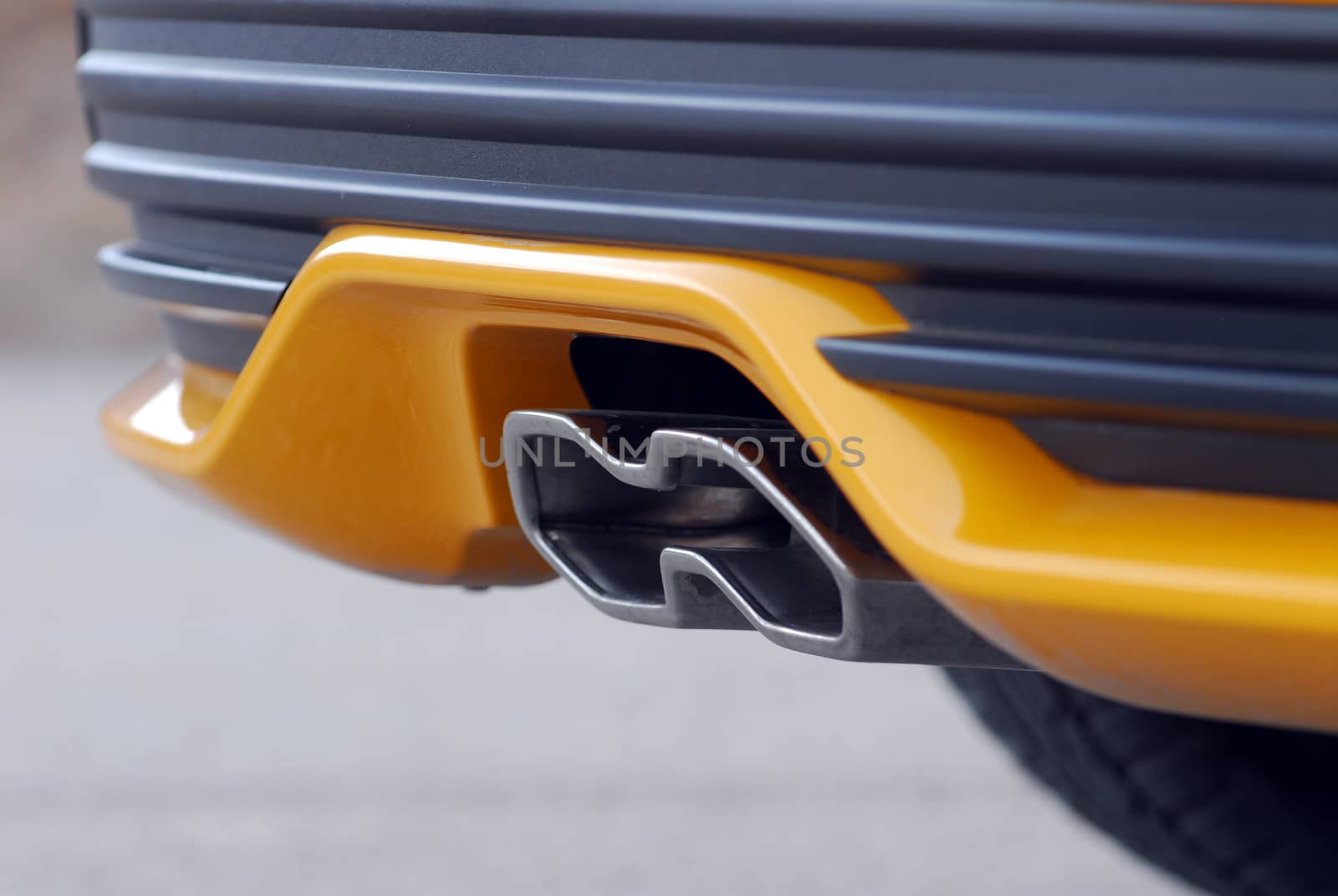 Close up of tailpipe on yellow sports car