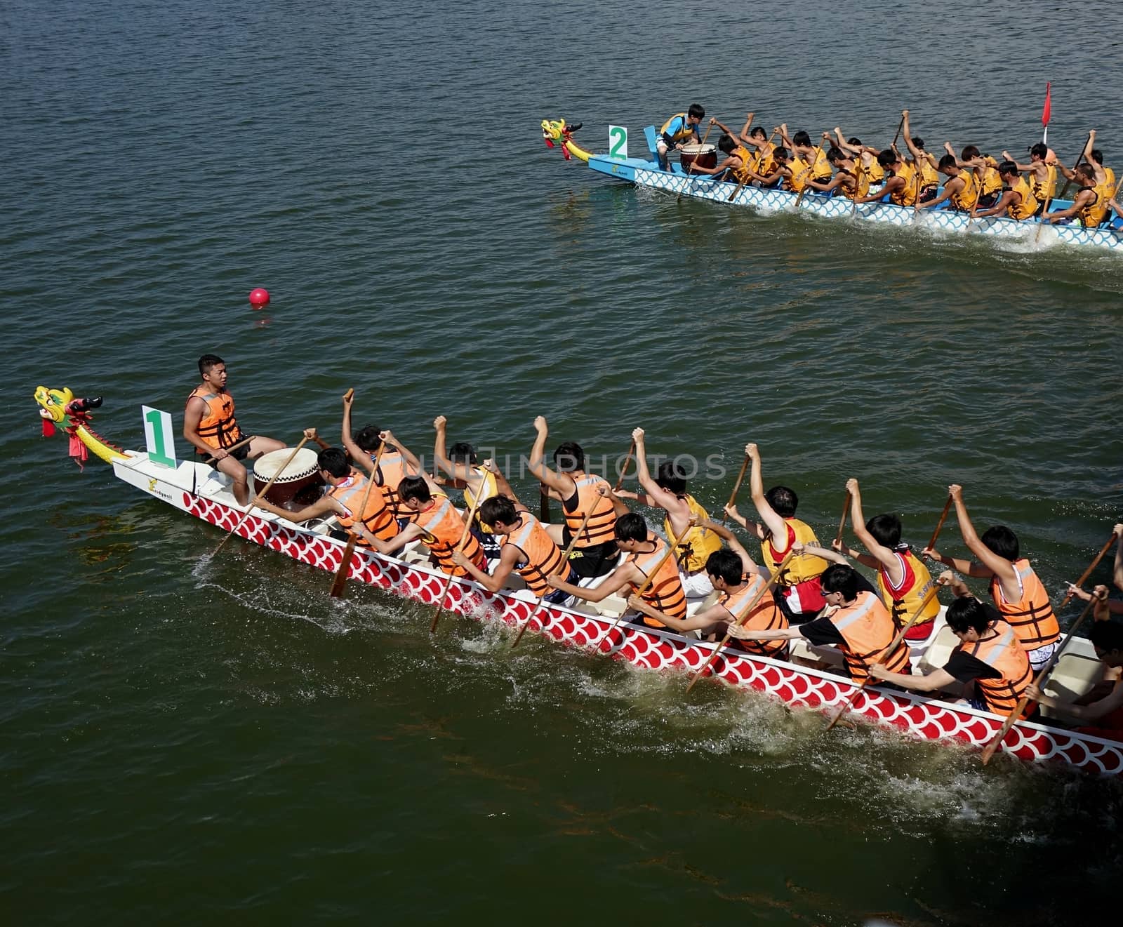KAOHSIUNG, TAIWAN -- JUNE 1, 2014: Two unidentified teams take part in the 2014 Dragon Boat Event on the Lotus Lake.