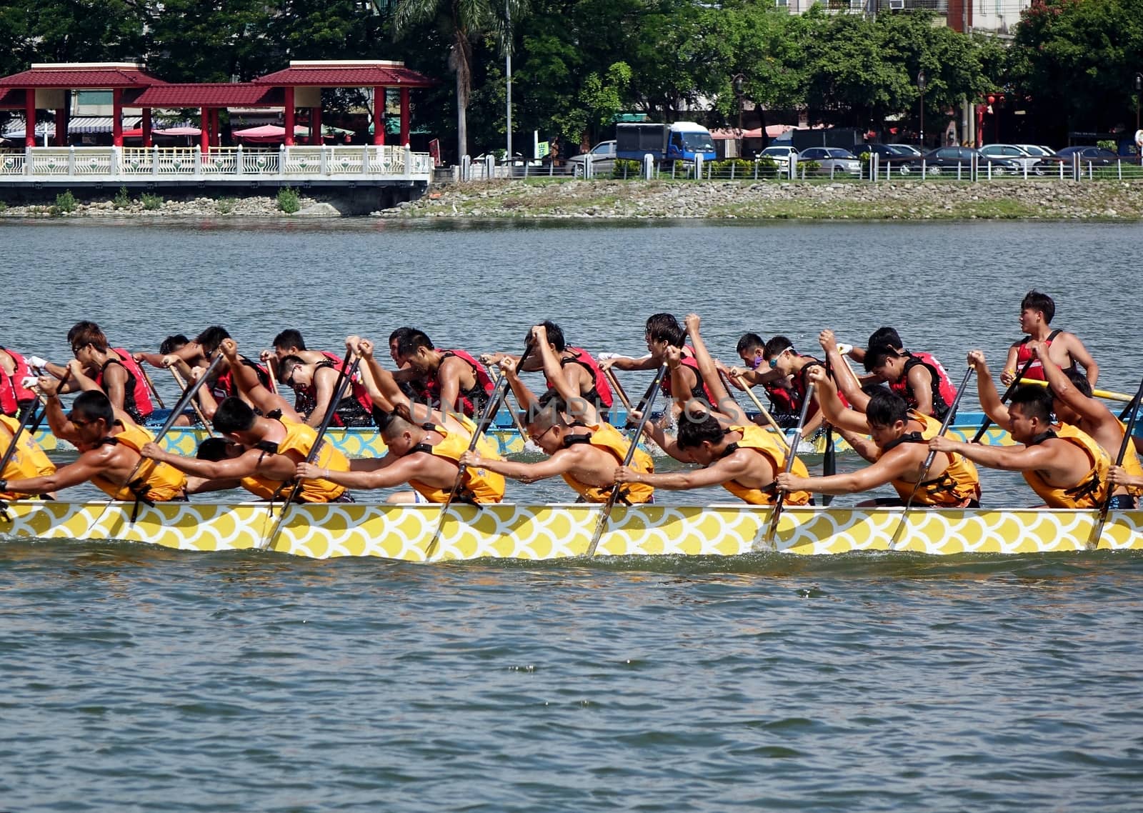 KAOHSIUNG, TAIWAN -- JUNE 1, 2014: Two unidentified teams take part in the 2014 Dragon Boat Event on the Lotus Lake.