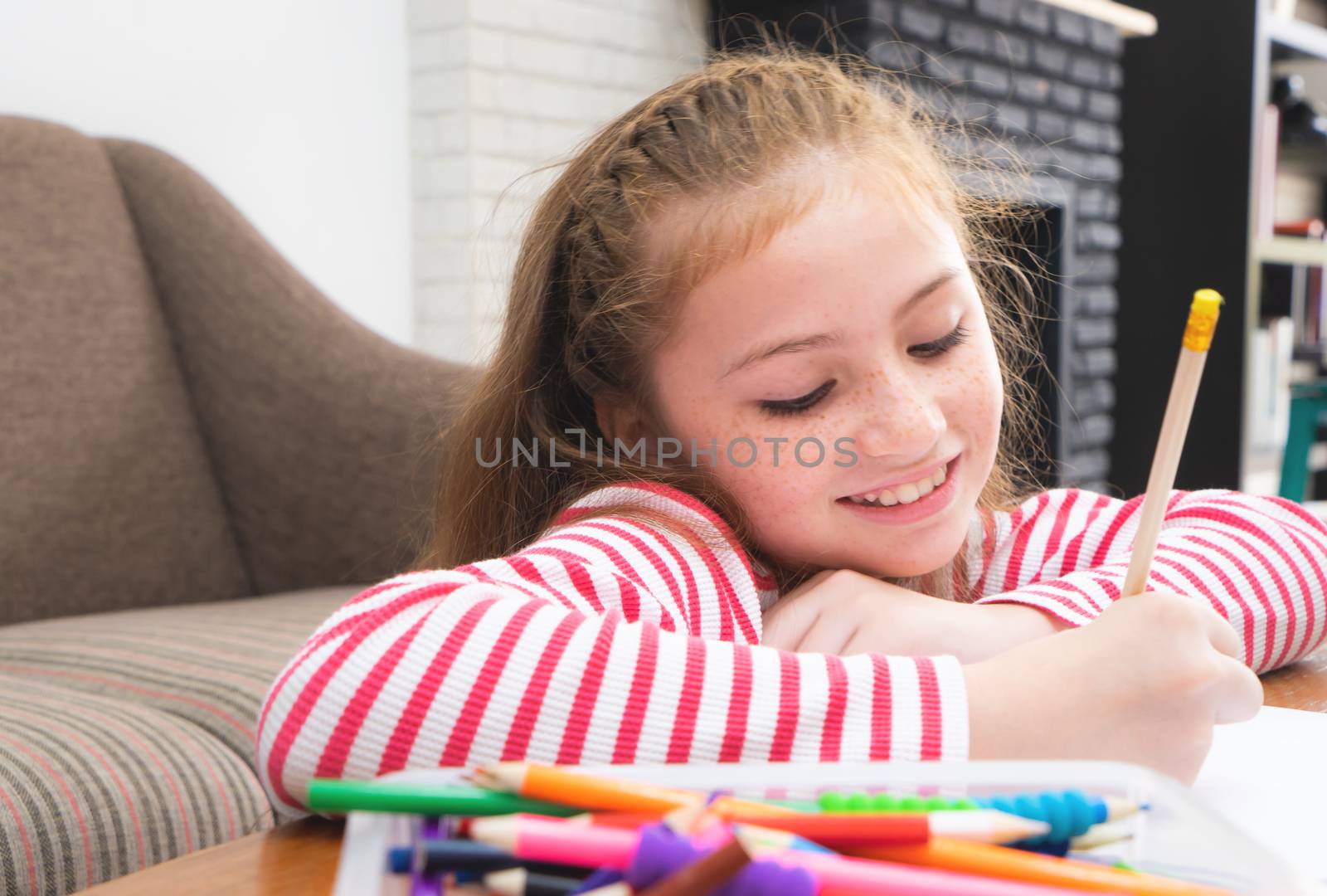 Kid Girl is pencil coloring on paper in living room by junce