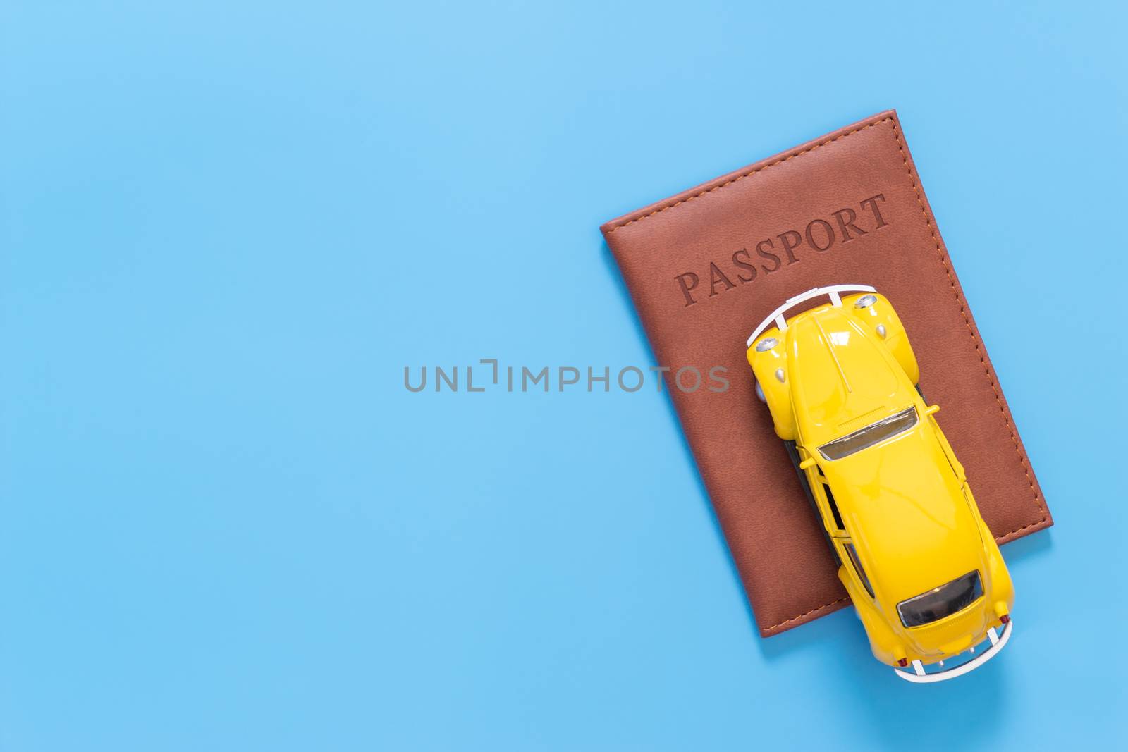 Summer travel accessories with passport and car on blue