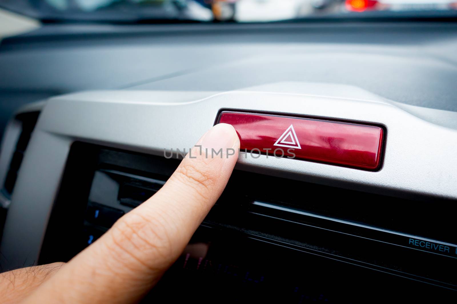 Pushing Red light hazard emergency button on a car console by junce