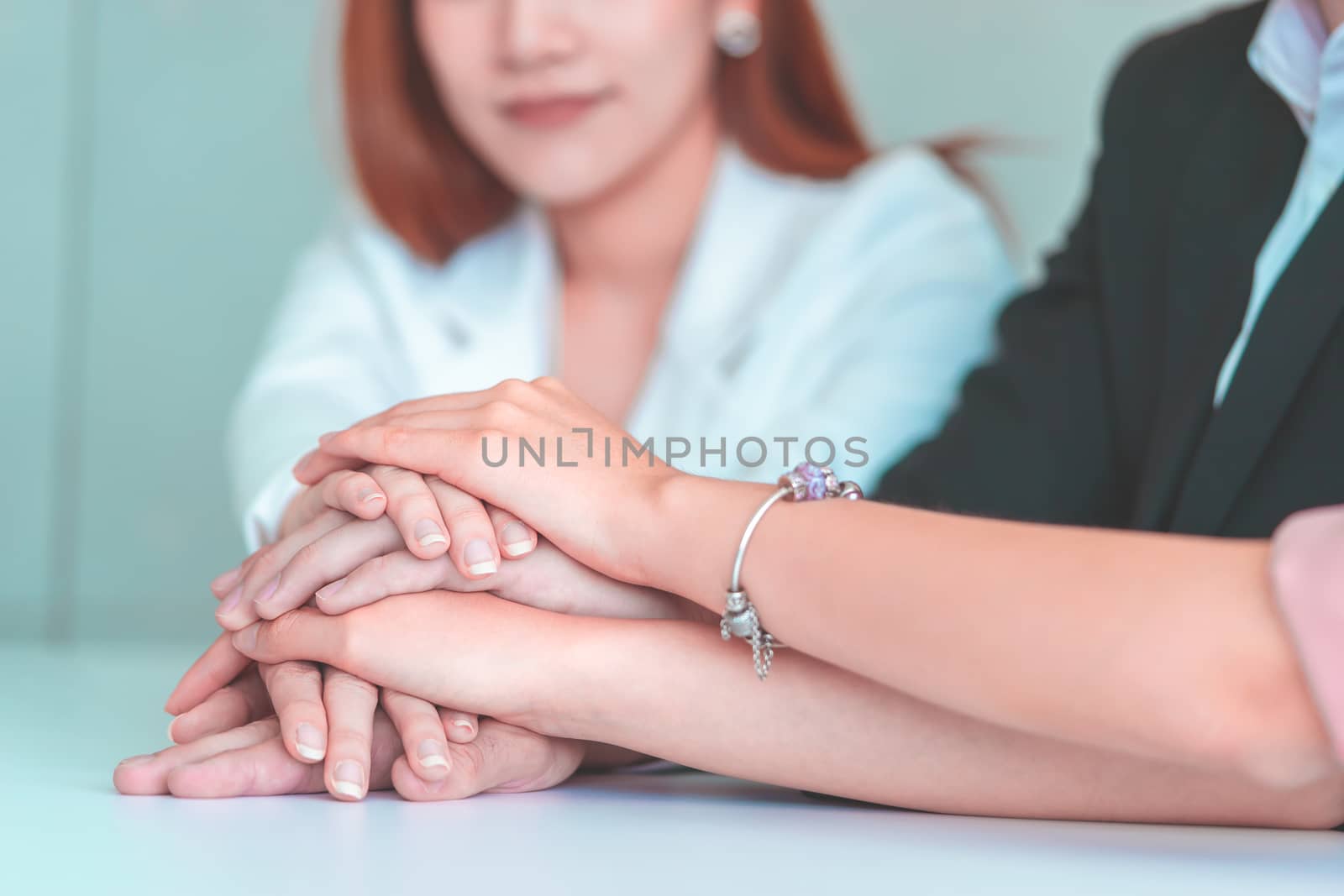 Office people putting hand together for business team success concept