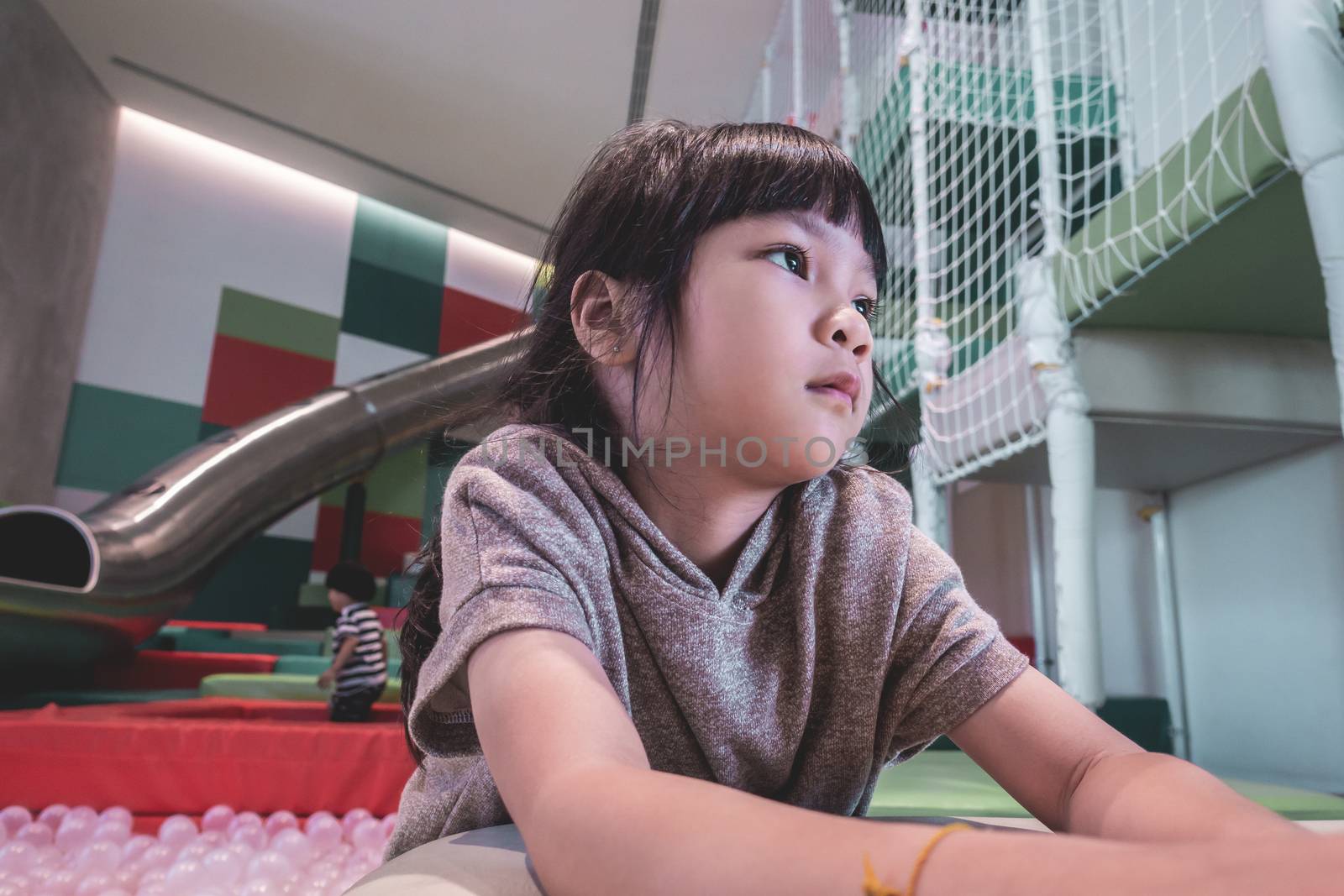 Portrait of an Asian Girl playing in playground by junce