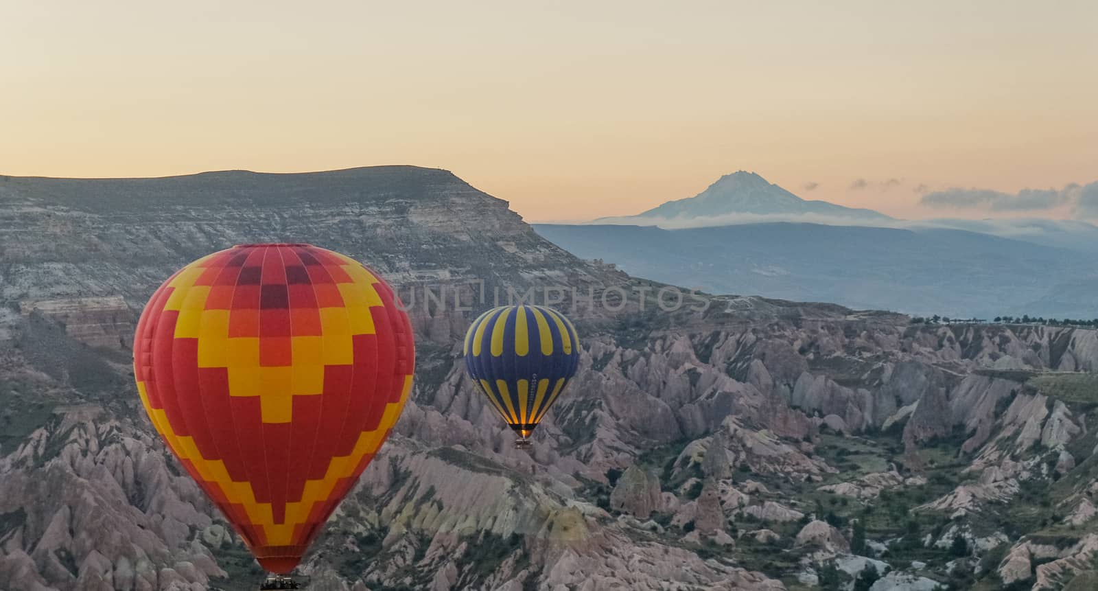 Ride with the hot air balloon over the rugged landscape of Cappadocia, Anatolia, Turkey