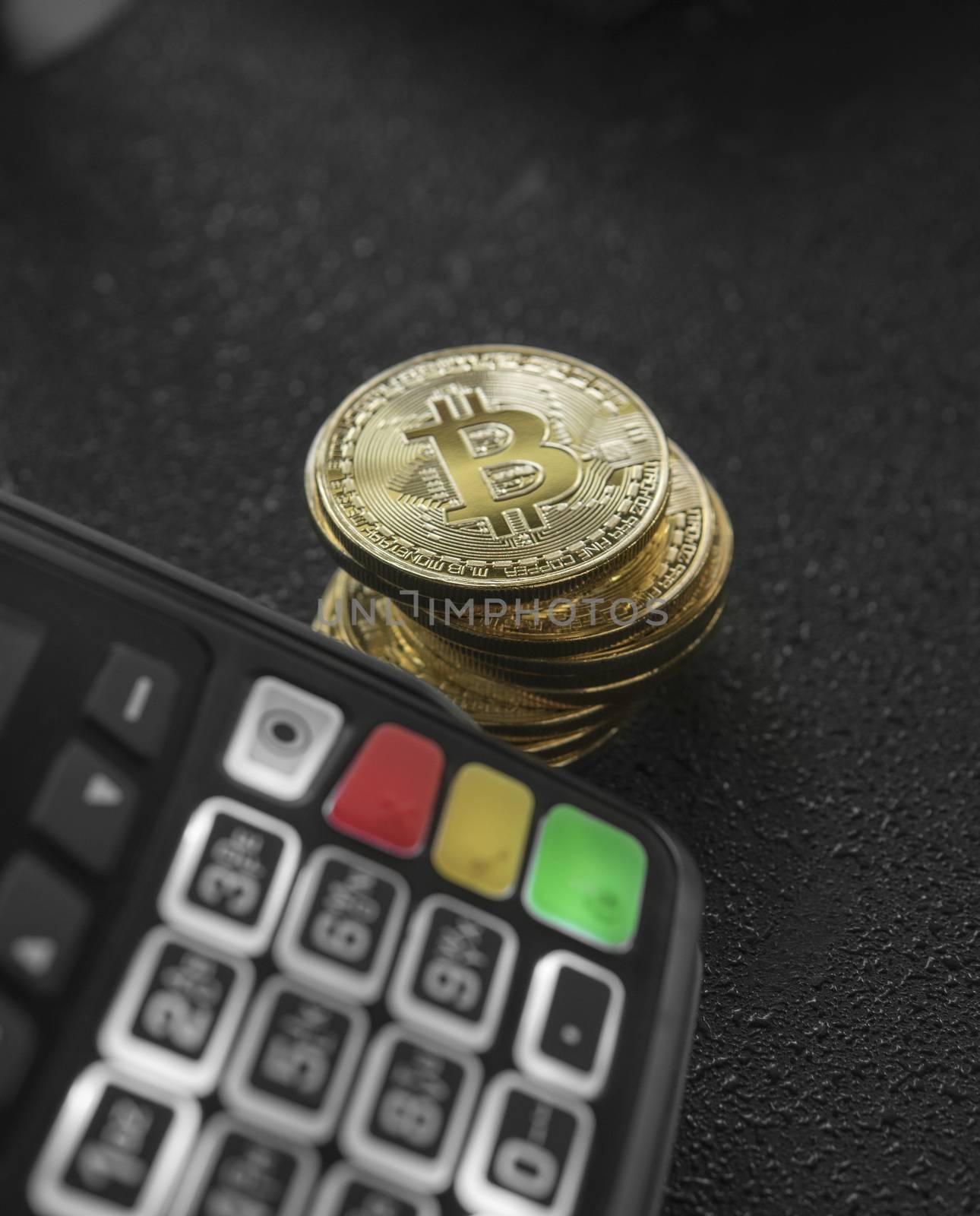 A pile of gold Bitcoin coins and POS terminal. Bitcoins Cryptocurrency. E-commerce, business, finance concept, banking and paymant