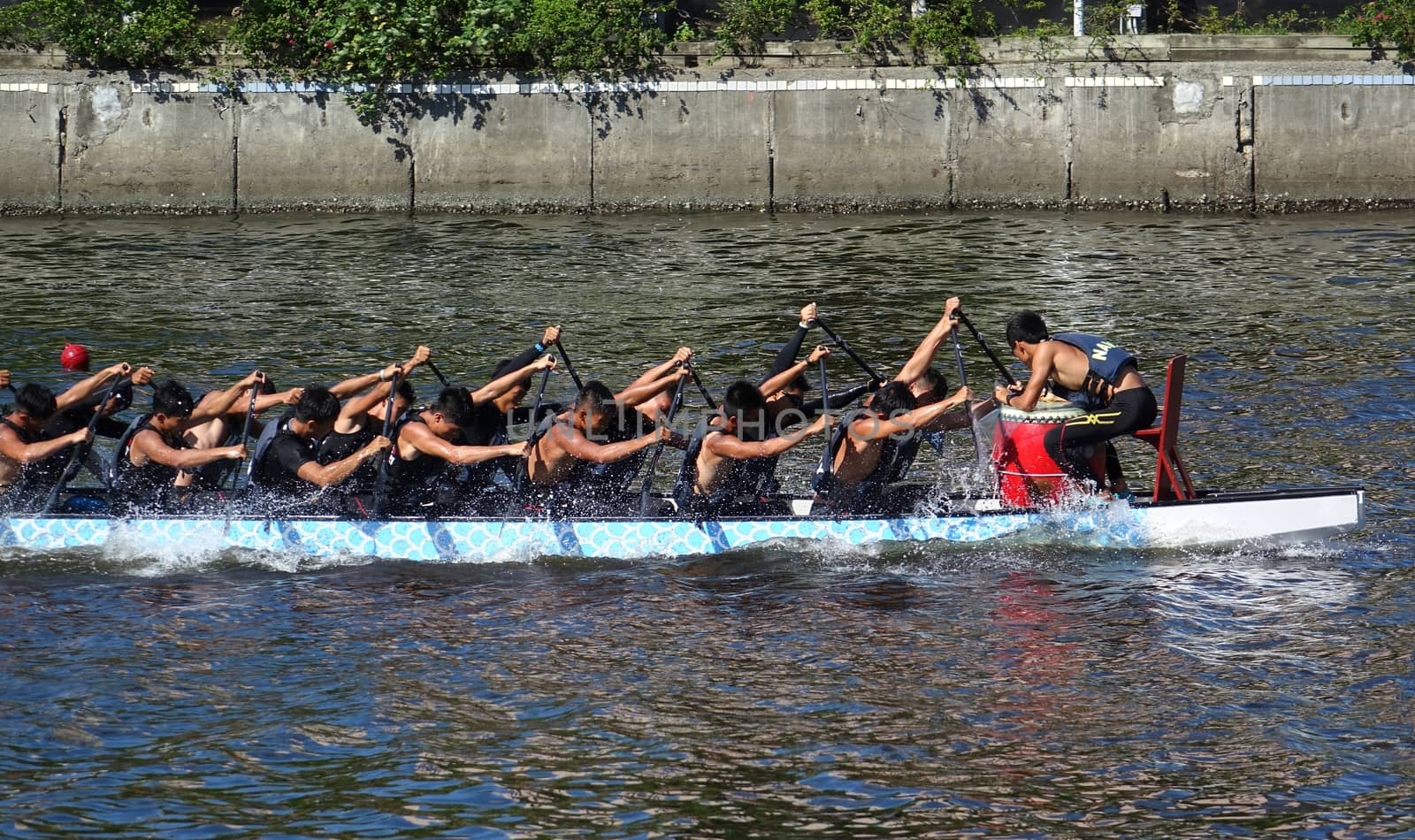KAOHSIUNG, TAIWAN -- JUNE 14, 2015: An unidentified team of rowers trains for the upcoming Dragon Boat Races on the Love River.