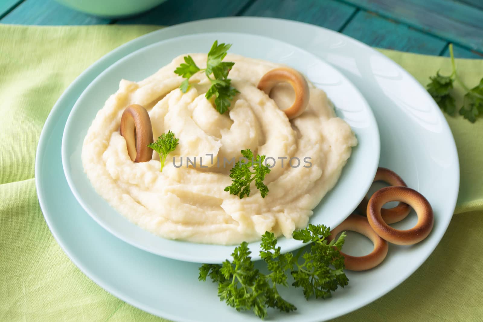 Homemade mashed potatoes in a bowl with parsley and russian bublik.