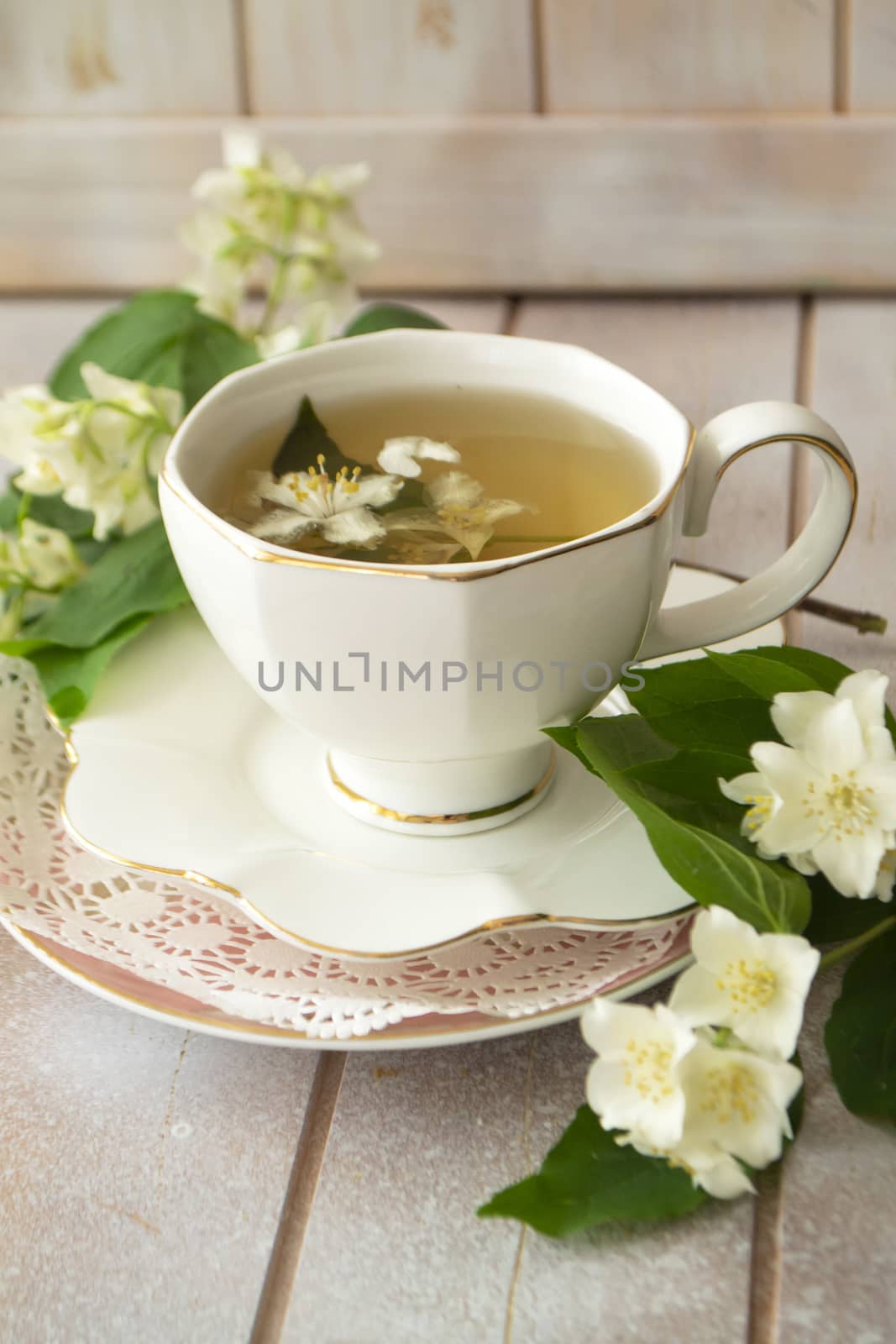 Jasmine herbal tea on a shabby wooden table, vertical image