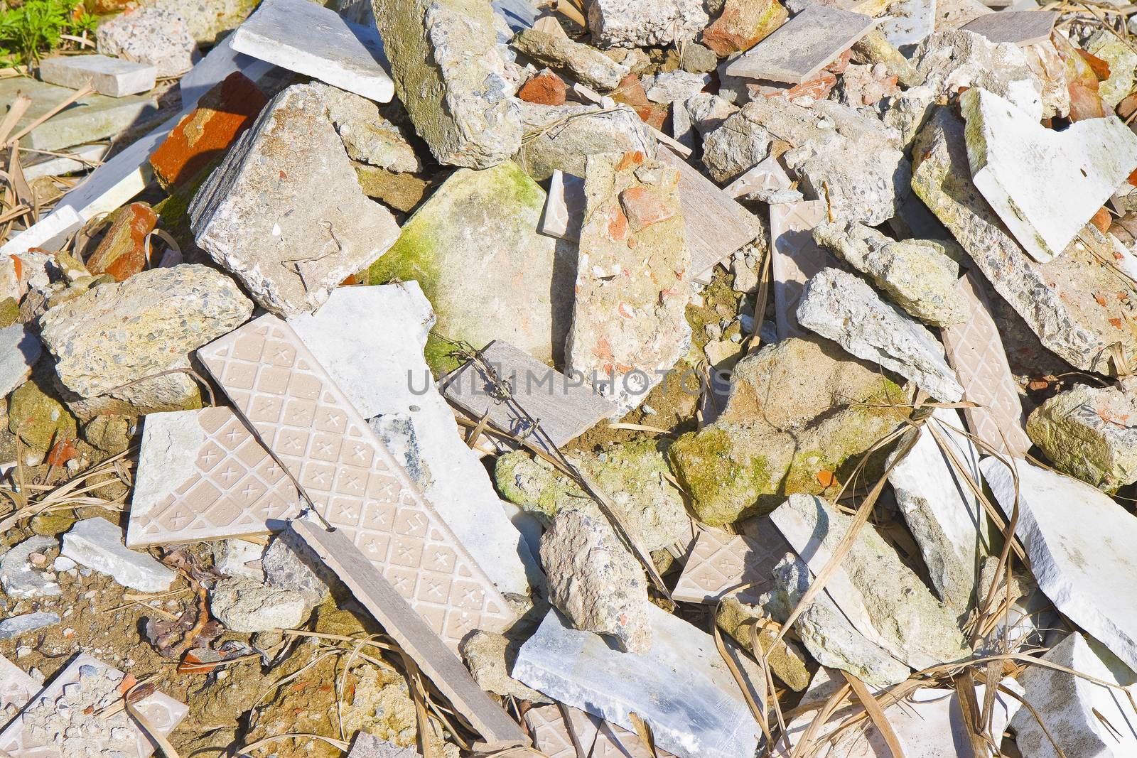 Concrete and brick rubble debris on construction site after a demolition of a brick building