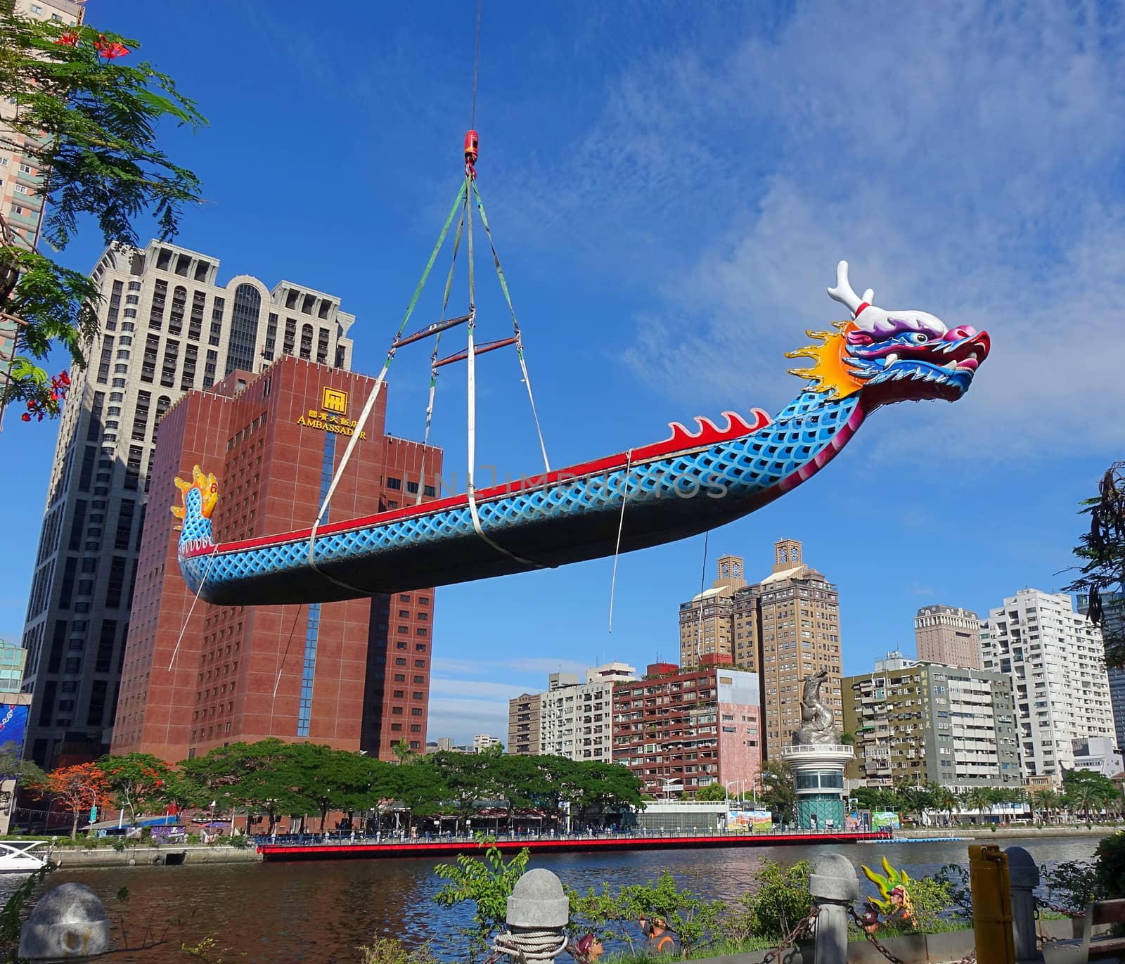 KAOHSIUNG, TAIWAN -- MAY 27, 2016: A crane lowers a dragon boat into the Love River in preparation for the upcoming Dragon Boat Festival.