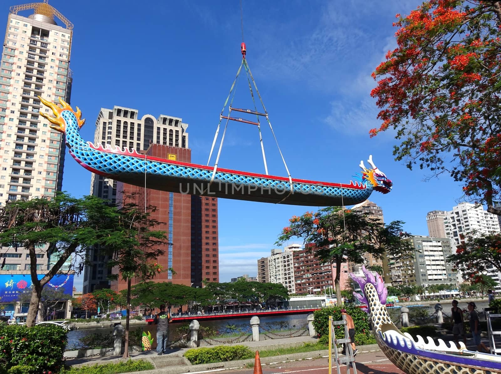 KAOHSIUNG, TAIWAN -- MAY 27, 2016: A crane lowers a dragon boat into the Love River in preparation for the upcoming Dragon Boat Festival.