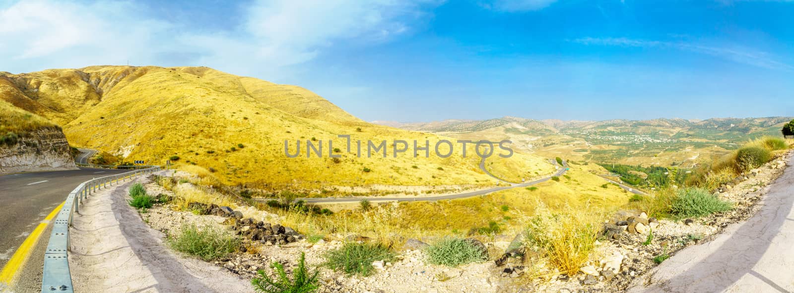 Panoramic landscape of the Golan Heights, winding road 98, and the Yarmouk River valley, near the border between Israel and Jordan