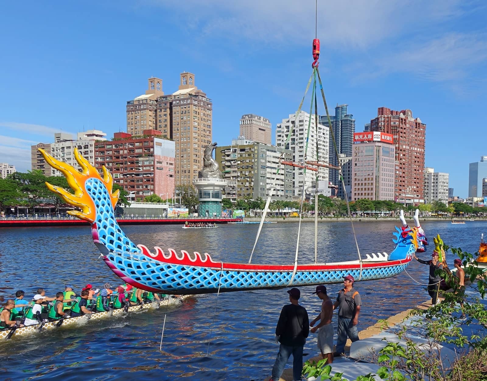 KAOHSIUNG, TAIWAN -- MAY 27, 2016: A crane lowers a dragon boat into the Love River in preparation for the upcoming Dragon Boat Festival.