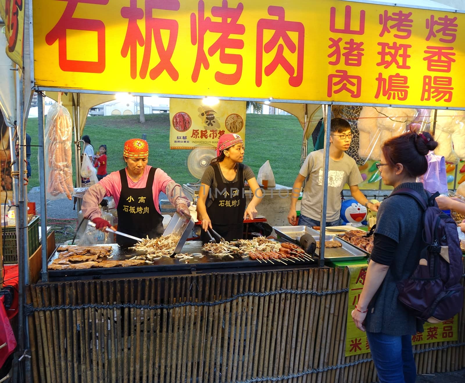 KAOHSIUNG, TAIWAN -- FEBRUARY 13, 2016: A stall sells indigenous foods cooked on an iron griddle during the 2016 Lantern Festival.

