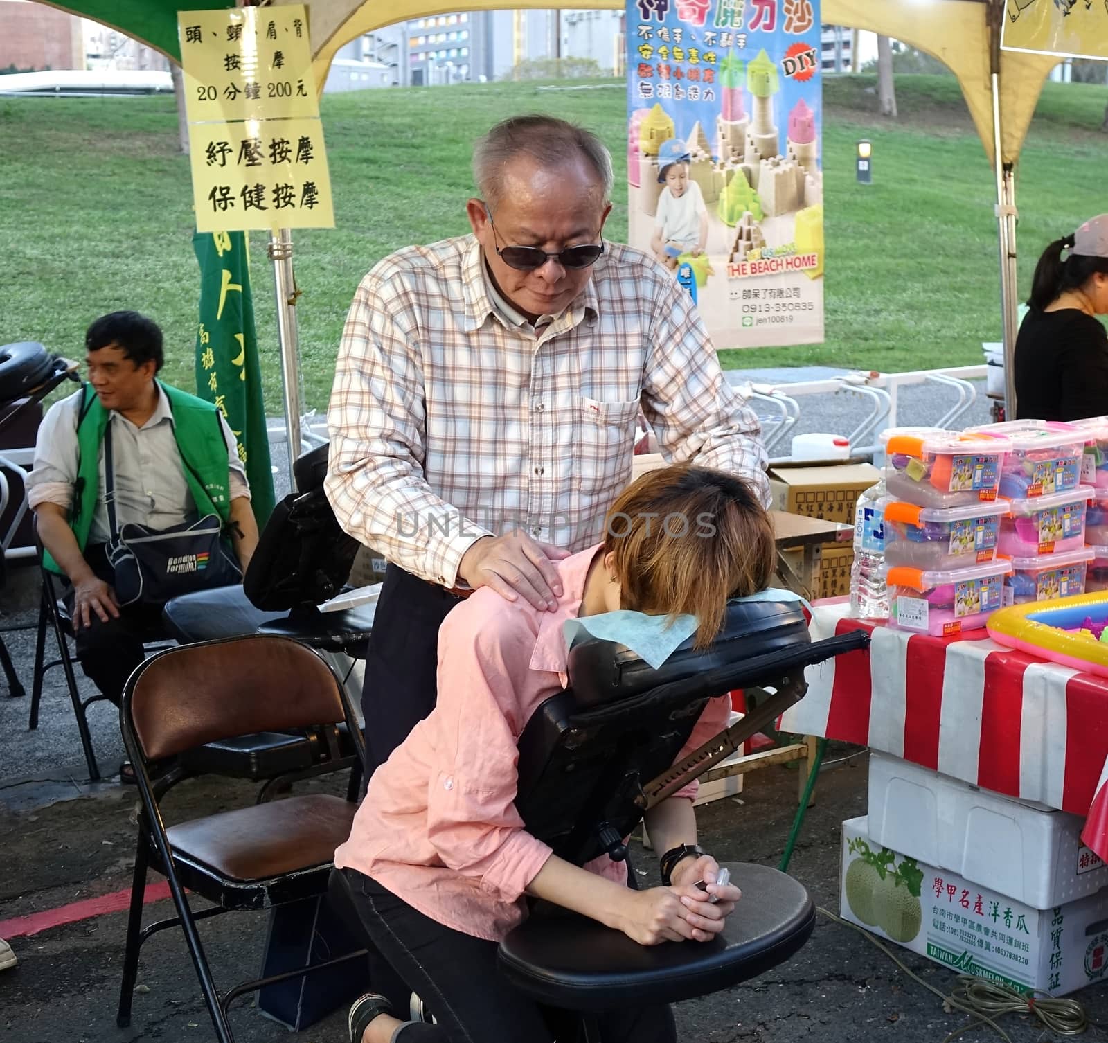 KAOHSIUNG, TAIWAN -- FEBRUARY 13, 2016: Vision impaired people offer massage services  during the 2016 Lantern Festival.
